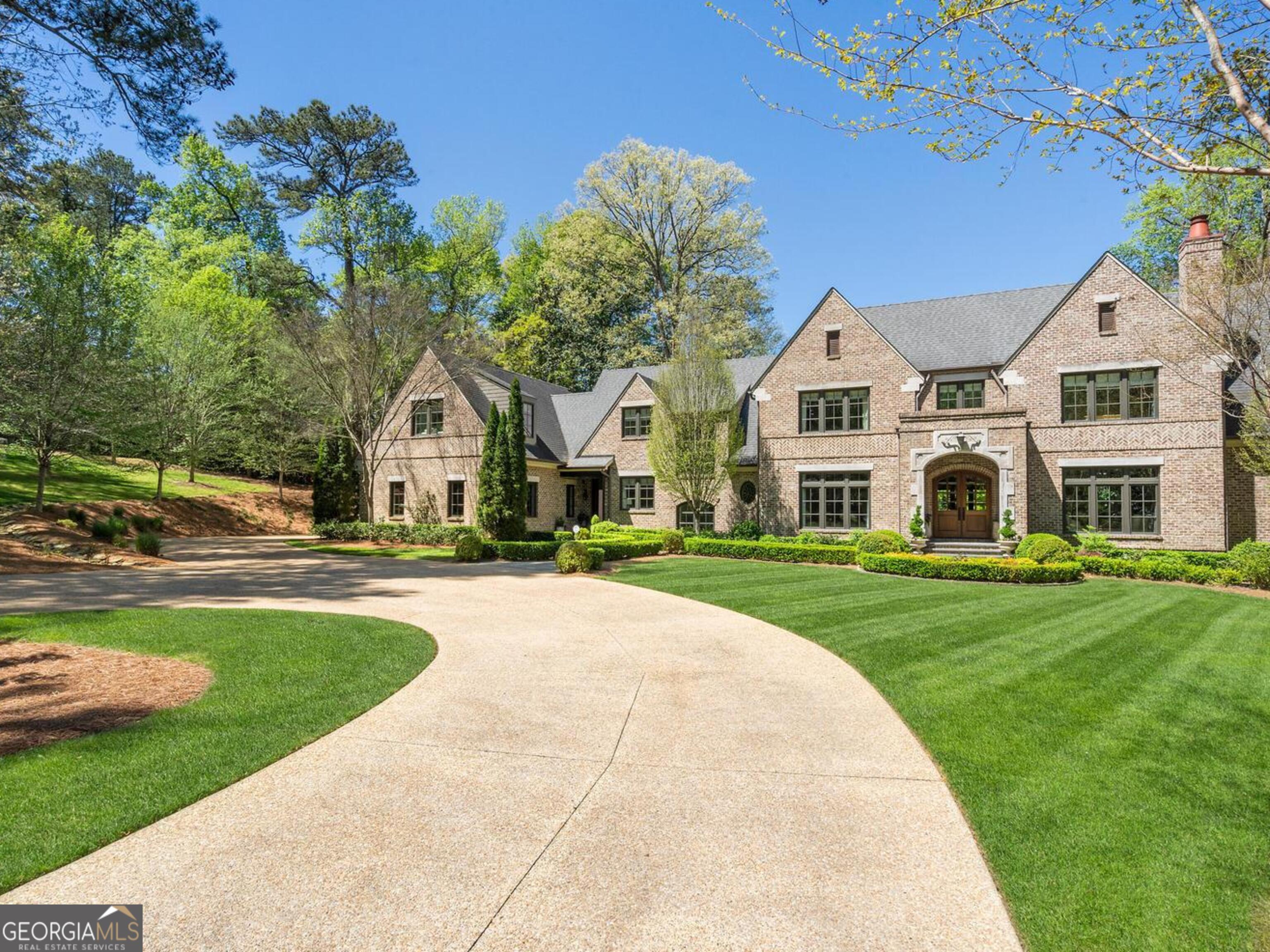 Nestled at the end of a tranquil lane in the prestigious enclave of Buckhead, this meticulously crafted custom estate spans over 2.1 acres of lush, level grounds. Designed by the renowned architects Harrison Design and completed in 2014, and then the terrace level finished in 2019, this masterpiece showcases unparalleled attention to detail and superior craftsmanship. Constructed by builder Tony Reaves of Intown Builders Group, this residence offers a private haven in a serene setting just moments away from esteemed educational institutions such as Pace Academy, Lovett, and Westminster schools.  Situated in an enclave where minimum lot sizes are 2+ acres, this distinguished property boasts an exceptional floor plan that seamlessly integrates indoor and outdoor living, with expansive spaces that open to the inviting pool and verdant surroundings. This home also features a whole house generator and space for an  elevator to all three levels.  The main level presents a sumptuous primary retreat with direct access to the pool and spa, creating a luxurious haven for relaxation. Upstairs, discover three gracious bedroom suites alongside a guest suite apartment, complemented by an additional living area and a private office or artisan's studio.  The newly constructed daylight terrace level offers a haven for entertainment enthusiasts, boasting a spacious area perfect for watching sports, complete with a well-appointed bar featuring a tap. Further enhancing the lifestyle offerings are a gym, guest suite, and two full bathrooms, providing ample space for both leisure and accommodation.  Rarely does a residence of this caliber become available in such an esteemed locale, making this exceptional property a rare gem in the coveted Buckhead neighborhood.