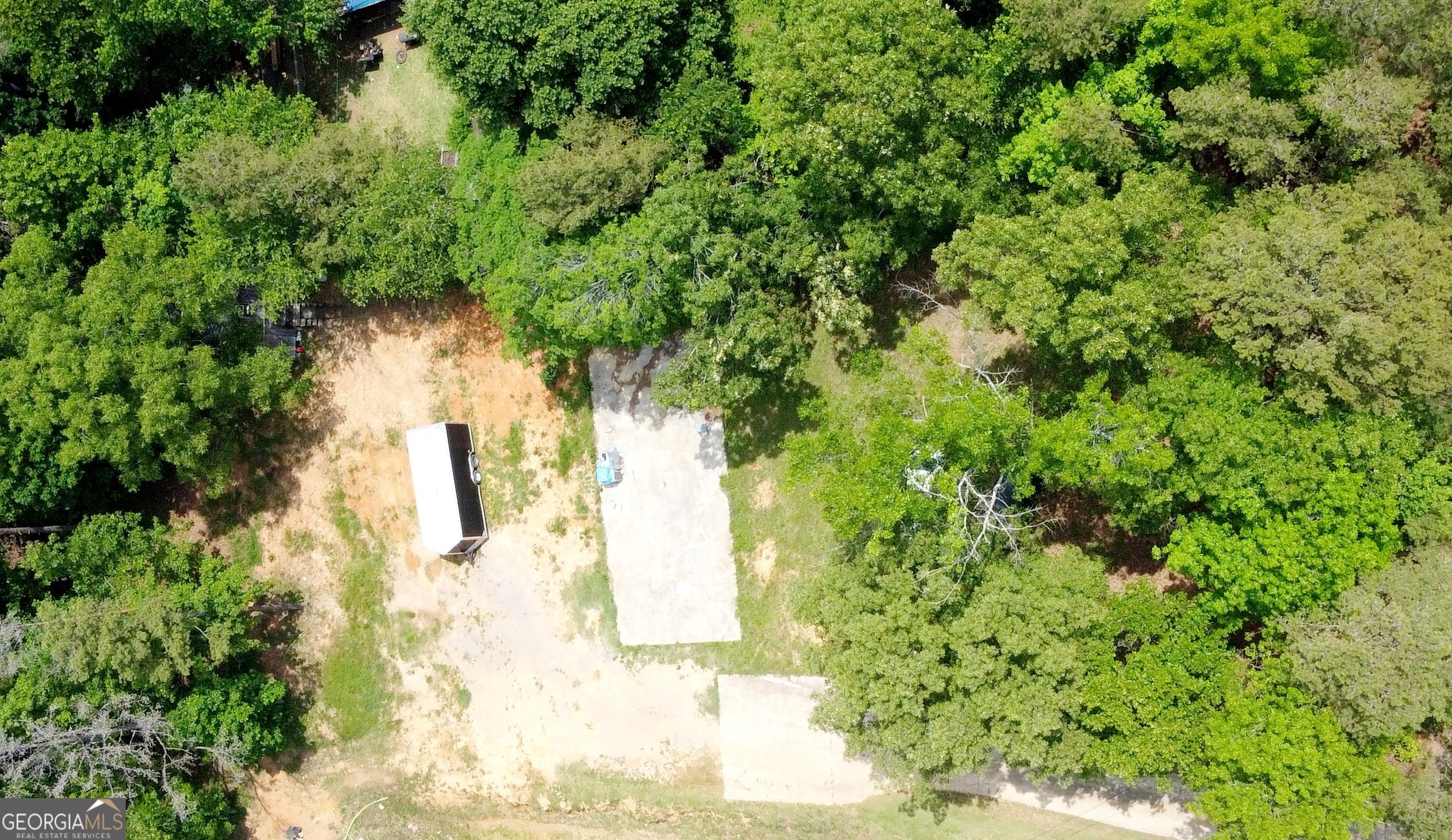 Looking for the perfect spot to build without starting from scratch? This .53-acre lot in Cartersville, Georgia, offers a rare opportunity with key improvements already in place. Previously home to a modular residence, the property includes a 23x60 concrete pad, a septic system that has been inspected, pumped, and certified, along with public water and electricity on-site.. making it easy to jumpstart your next project. Tucked away near Mission Road Elementary, this lot delivers the best of both worlds: peaceful country charm with views of open fields and farm animals, yet just minutes from downtown Cartersville's vibrant shopping, dining, and entertainment scene. Adding even more value is a two-story, 18x30 building on the property. While the exterior could use a little TLC, the interior is in great shape and offers endless potential, whether you're dreaming of a workshop, guest suite, or extra storage space. This isn't just land, it's a head start on your next chapter in one of Cartersville's most scenic and convenient locations.