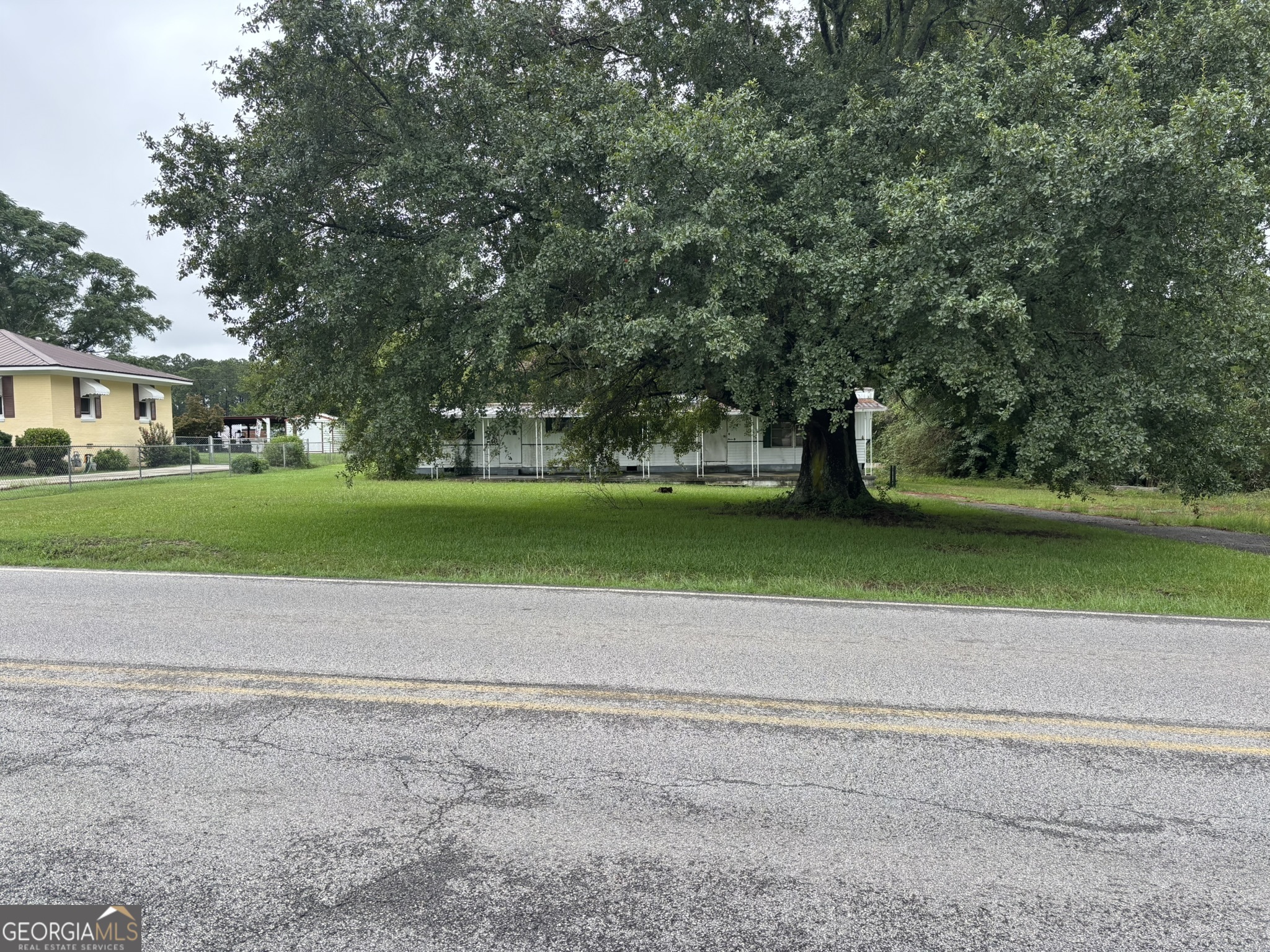The trailer is unhabitable-commercial use to be confirmed by Baldwin County Planning and Zoning. Public water and sewage to be confirmed with Baldwin County/City of Milledgeville. The trailer was once a rental unit, and a septic system was installed.