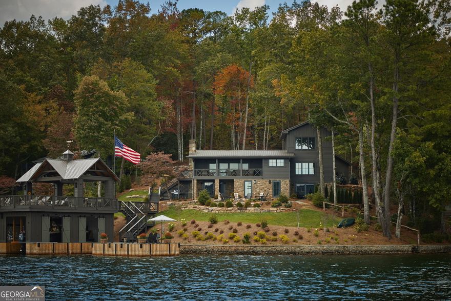 Discover the unparalleled lakefront retreat at 2569 Blalock Goldmine Rd, an exquisite deep-water property on a point offering unobstructed 270-degree views of Lake Burton's Big Basin, Hogg Island, and iconic Charlie Mountain. This completely reimagined 4-bedroom, 4.5-bathroom masterpiece blends modern luxury with timeless lake house charm, delivering an extraordinary waterfront lifestyle.    Recently gut-renovated to perfection, this stunning residence boasts a thoughtfully designed open floor plan with Hardie Plank siding and wall-to-wall Pella windows that frame breathtaking lake views from nearly every room. The kitchen is both an entertainer's and a chef's delight, featuring a large island for entertaining and a scullery for cooking and cleaning---complete with KitchenAid appliances, custom cabinetry, and leathered granite. The spacious great room with vaulted ceilings and a stone fireplace flows seamlessly onto a generous lakeside screened-in porch, ideal for sunset cocktails and alfresco dining. Each of the four ensuite bedrooms is a private retreat, offering luxurious finishes and spa-like bathrooms. The primary suite is a true sanctuary, boasting upscale amenities like a California closet system with wardrobe lighting, and lakeside amenities like massive French sliding doors that open to a private stone terrace just steps from the lake. The primary bath exudes natural elegance with limestone tiles and abundant natural light, perfectly reflecting the home's harmonious balance between luxury and comfort. The terrace level also includes a well-equipped wet bar, lakeside laundry room, second living room with walkout stone terrace, and ample-sized walk-in pantry with thoughtful built-ins. Situated on one of Lake Burton's premier point lots, this property offers exceptional lake frontage, deep water, panoramic lake views, and a brand new oversized two-story/two-stall boathouse with maintenance-free decking, year-round boat accessibility, and a grandfathered diving board! Relax on the expansive swimming dock, screened-in porch, or around the stone firepit, all intentionally designed to maximize your connection to Lake Burton's natural beauty. Enjoy the lush Wilkinson-designed and maintained landscaping, complete with irrigation, lighting, and accent fencing. Additional amenities include a whole-house generator, an oversized detached two-car garage, ample parking for guests, and a paved driveway. This is a rare opportunity to own one of the most sought-after properties on Lake Burton---where every detail has been meticulously crafted to create a one-of-a-kind lakefront escape . . . turnkey and ready for Memorial Day Weekend!