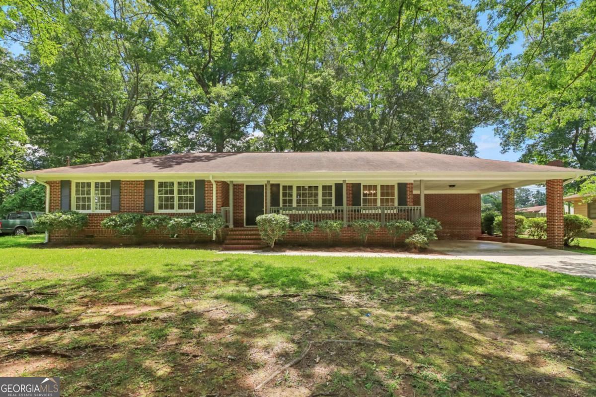 Stunning, all brick ranch home with beautiful updates throughout! This 3-bedroom, 2 full bath home has awesome curb appeal. Very classic brick exterior with covered front porch, and spacious attached carport. Walk inside to a very clean, modern, yet approachable interior. Renovated kitchen features new cabinets, counter tops, fixtures, and appliances that are included. New flooring, paint, light fixtures everywhere else. Two full bathrooms with updates. Walk out back to a large screened in porch, and oversize rear deck to enjoy a very nice backyard. In said backyard included a massive storage building that has many uses. Storage, workshop, vehicle housing, gym, and much more. Great location just minutes to highways, and downtown Griffin.
