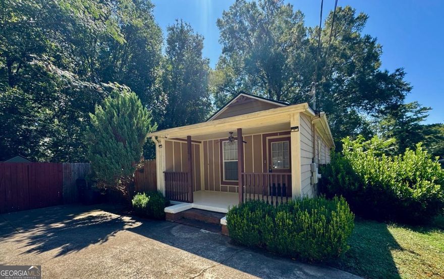 New Price! ** Great opportunity to live in downtown Acworth close to amazing restaurants and shopping! This two bed, one bath bungalow has a lot of charm and character with a lot of potential. Private wooded lot backs up to green space and is fenced in with a backyard patio and a covered front porch. New roof, hardiplank siding, double sided fireplace (decorative only now) built-in bookshelf, walk-in closets, beautiful hardwood floors and tile in the kitchen and bath. Prime location close to Lake Allatoona, Lake Acworth/Acworth Beach, I-75 and Hwy 92.