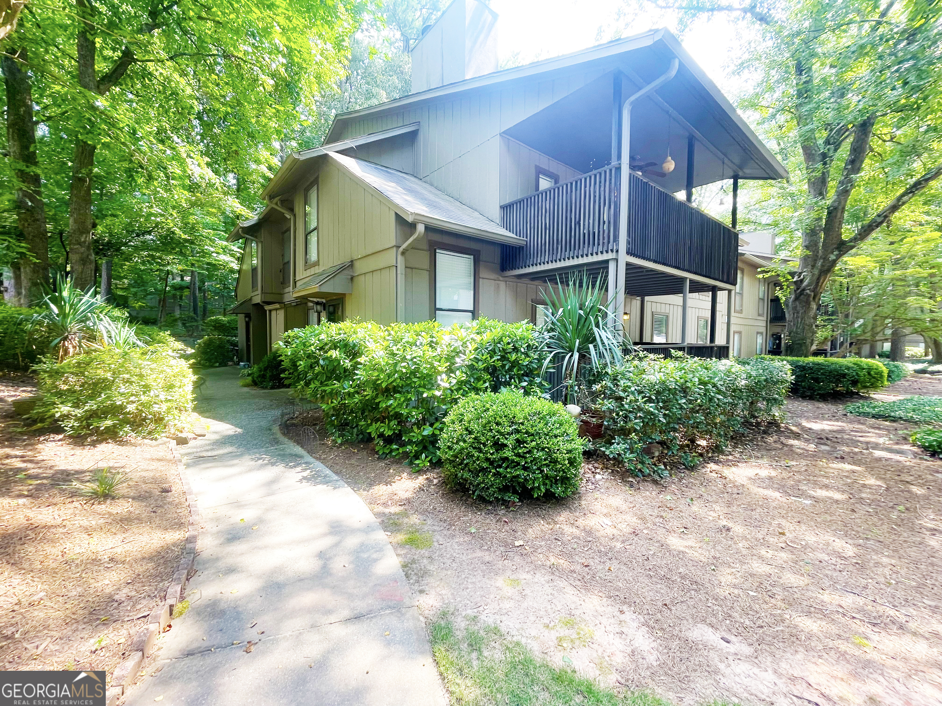 Welcome to this charming 2-bedroom, 1-bathroom condo ideally located in the heart of Smyrna. Step inside to an inviting family room featuring a cozy fireplace, perfect for relaxing evenings. The kitchen offers white cabinets, granite countertops, stainless steel appliances including a gas range, and a convenient breakfast bar. The primary bedroom features a spacious walk-in closet and direct access to the shared bath. Enjoy your morning coffee or unwind in the evenings on the covered patio overlooking the community grounds. This sought-after community offers fantastic amenities, including two swimming pools, lighted tennis courts, and two dog parks, providing endless recreation options. Located just minutes from Cumberland Mall, Truist Park, The Battery, and with easy access to I-75 and I-285, this condo is perfectly positioned for shopping, dining, and commuting. Don't miss out on the opportunity to own this low-maintenance home in an unbeatable location!