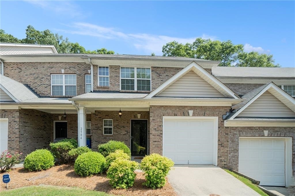 Welcome home to this cozy two bedroom-two and one half bath townhome close to shopping, Atlanta's Hartsfield Int Airport and major highway access. Both bedrooms are amply sized making this a great share. Tucked away on a quiet street in the community, the back patio overlooks a wooded area making it a nice retreat after a long day's work. The unit features a one-car garage and a parking pad for an additional vehicle. For the property's low maintenance, laminate hardwoods on main level, and open concept , the new owner need only bring their furniture to make it feel like home. Built by acclaimed builder, Patrick Malloy, Providence Place is a gated swim community and across a stone's throw from Old National Town Center. There was no trick photography needed--This unit shows as presented in the photos. Ask about incentives using preferred lender!