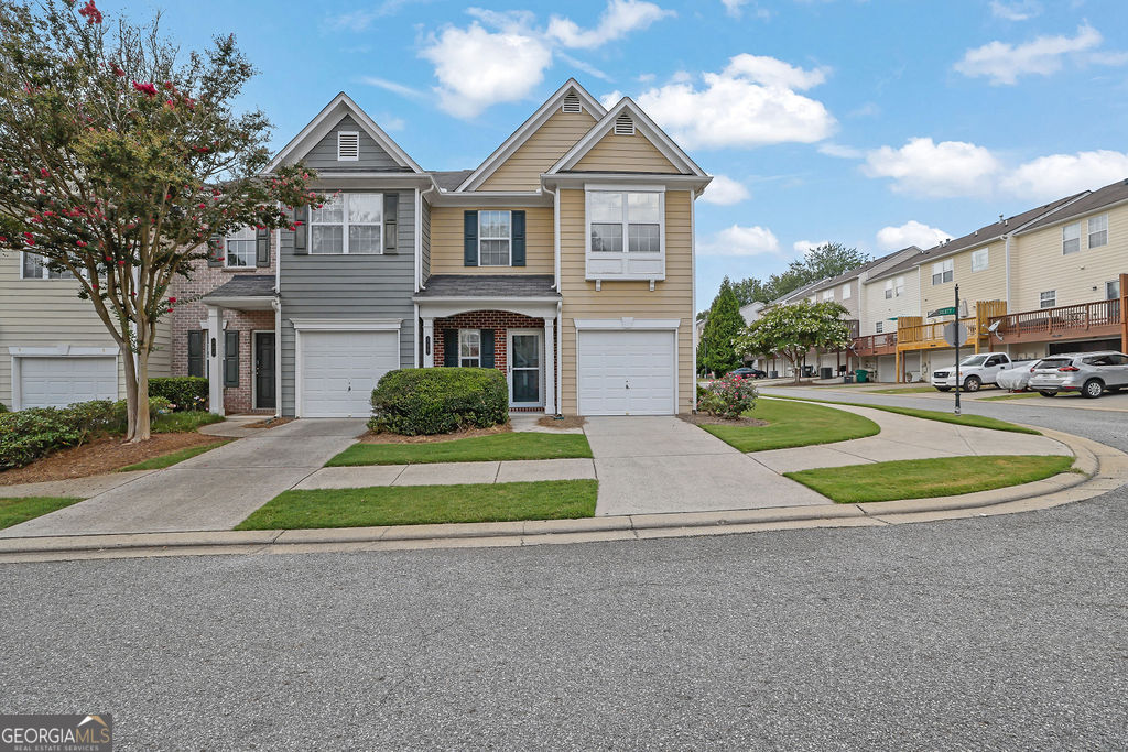 Welcome to this beautifully maintained end-unit townhome in the desirable Magnolias at Ridgewalk community in Woodstock! This spacious 2-bedroom, 2.5-bath home offers the perfect blend of comfort, privacy, and convenience-just minutes from vibrant downtown Woodstock and easy access to I-575. Step inside to an inviting open-concept floor plan featuring a bright living area and a spacious kitchen complete with room for two, beautiful appliances, and a large breakfast bar-perfect for casual dining or entertaining. Upstairs, you'll find two generously sized ensuite bedrooms, each with its own private bathroom and ample closet space. The oversized primary suite features a walk-in closet and double vanities for added luxury. A convenient upstairs laundry area and a main-level powder room add to the functionality of the home. As an end unit, this home enjoys extra privacy, additional windows for natural light, and a larger side yard-great for outdoor living or pets. Additional perks include a one-car garage and low-maintenance living in a quiet, friendly neighborhood. Don't miss your chance to own this turnkey townhome in one of Woodstock's most convenient and charming communities!