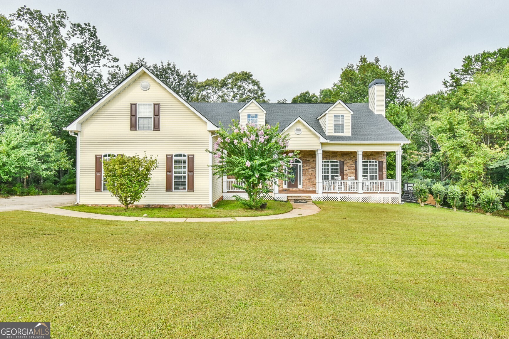 INCREDIBLE CUSTOM built Home in Highly Sought after Flowery Branch!! You do not want to miss this Beautiful Family Home with ample Space for EVERYONE !!! The home is situated on 2+/- Acres with NO HOA! You will be welcomed by a large rocking chair front porch. Enter into the 2 Story Family Room that has warm hardwood floors & fireplace along with tons of natural light that opens to the Formal Dining Room and Chefs Kitchen with Solid wood cabinetry & center island. Inviting MASTER SUITE on MAIN & large secondary bedrooms. Amazing and private screened in back porch & Deck Perfect for Entertaining. EXPANSIVE finished basement with IN LAW SUITE, separate driveway and a 3 CAR GARAGE, along with the 2 car garage on main level for a total of 5. The home offers a HUGE detached Workshop that completes this AMAZING home that WILL NOT LAST LONG!!! Move Up to Any One of Our Listings, We'll Buy Your Home for CASH!* Your family with LOVE this home! Call or text RU4 Homes Team for a private showing today!