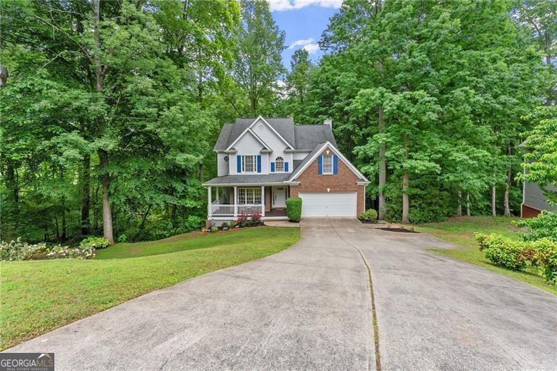 Nestled in Alpharetta's sought-after West Forsyth district, this home in Hamptons Grant offers the perfect blend of elegance and comfort. As you step onto the front porch, you're greeted by the inviting charm of this home. Through the entrance, two-story foyer leads to the dining room area and staircase open to below. The main level features an updated kitchen with white cabinets, a large island, and a seamless flow into the breakfast nook and living room, ideal for entertaining or relaxed gatherings. The living room features a cozy fireplace and a stunning triple window framing picturesque views of the private, wooded backyard. Escape to outdoor bliss on the two-story back decks, offering ample space for entertaining guests or enjoying tranquil moments amidst the serene surroundings. With the potential to be screened in, these decks promise year-round enjoyment of the beautiful outdoors. Upstairs, there are three secondary bedrooms and a full bathroom, providing comfortable accommodations. The primary bedroom exudes luxury with a tray ceiling, triple windows framing scenic views, and an ensuite bathroom featuring a separate tub and shower, double vanity, and two walk-in closets. A large unfinished basement presents endless possibilities for customization, with access to the lower level deck adding to the versatility of this space. Throughout the home, abundant natural light floods the living spaces, enhancing the ambiance of warmth and openness. Beyond the lush greenery lies a private sanctuary, where flowing creeks and views of pastoral landscapes create an atmosphere of tranquility. Despite its central location, this backyard oasis offers a sense of seclusion and natural beauty