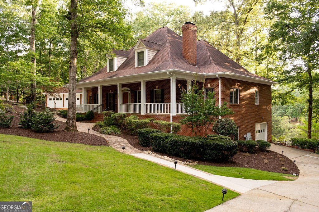 Lakeside Living Retreat--A rare, sought-after find in Athens, the coveted Shoal Creek community boasts limited lake living opportunities and this custom beauty is not only one of the few that boasts a picturesque lakeside setting, but also offers an amazing level rear yard to help you enjoy it all!! Upon approach the ethereal backdrop is stunning-set with custom landscaping, brick walkways, dual driveways, detached 2-car garage, and wrap-around front porch all drawing you in. Not your everyday plan, this expansive footprint was custom designed to not only provide ample space for room to expand, but was also crafted to enjoy sparkling lake views from many angles. Welcomed by the formal layout, the foyer is flanked by a spacious formal dining room that could easily seat 8+ and a grand living room with central, marble-accented fireplace commanding the space. Tucked away off the living room is the ideal home office or study, perfectly sunlit. By now you've noticed several desirable features that appoint this lovely home, such as; 10ft. ceilings, hardwood and ceramic tile floors, new upgraded plush carpet, extensive trim and moldings package, decorative light fixtures-many with dimmers, double paned windows, floored attic storage options, and more. Serving lake house vibes, the entertainer's kitchen overlooks the sunroom styled breakfast room and keeping room engulfed with views of the lake. Well-equipped, the spacious kitchen features 360' of custom cabinets, sprawling granite counters that extend to the breakfast bar, tile backsplash, double-basin, under-mount sink with instant hot water dispenser, large pantry with shelving, and a complete appliance package including wall oven. The cozy keeping room boasts a masonry fireplace flanked by custom builtins, and is the heart of the home where many memories will be shared. Down the hallway you will find many conveniences like the laundry room complete with utility sink, powder room perfect for guests, access to the terrace level and tucked away at the end, the private owner's suite. A true retreat, this oversized primary bedroom offers ample space for large furniture, multiple spacious closets, ensuite full bath and of course lake views. Start your morning off right with the picture windows reflecting the lake in the primary lavatory, or enjoy a bubble bath for added relaxation. Ascend the stairs to find 3 additional bedroom options, plus 2 full baths. The upper level also houses an additional bonus space or home office that provides access to stairs leading to the 3rd floor attic storage. If you enjoy entertaining, in need of room to expand or looking for inlaw suite potential the finished terrace level is ready to serve. Boasting an oversized rec. room, wet bar with cabinets perfect for a kitchenette, full bath, lower level garage and exterior access, this daylight basement provides upgraded amenities that allow the space to be utilized in many ways. The desirable features continue to the exterior where you can enjoy year-round living with the screened porch or enjoy dining al-fresco lakeside on the oversized rear patio. Follow one of the stone or concrete paths to the fenced rear yard, lower level patio, and banks of the lake to relish in a little afternoon fishing. The exquisite scene this 1.01 acre lot exudes must be seen in person to truly appreciate its authenticity and beauty. Welcome home to Millstone Circle.