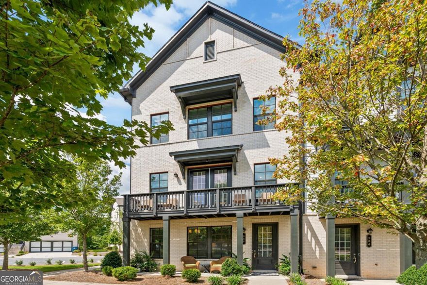 TURNKEY, PRISTINE, LIGHT, BRIGHT, END UNIT with upgrades galore! Prime location - Walk to Lifetime Fitness, 1.3 miles to Avalon for shopping, dining and entertainment! Easy walk to Alpharetta High School, Marta park and ride and a short drive to downtown Alpharetta, Halcyon and Webb Bridge Middle School. Beautifully maintained, deep cleaned, largest floor plan in the community with 4 bedrooms, 3 full and one half baths. Terrace level boasts a generous garage with fantastic features leading to a beautiful entry hall with a full bedroom and full bathroom with shower. Ascend the stairs to your gracious and spacious main living area. Relaxing and entertaining family is a breeze with the large family room with gas fireplace, dining area with Butler's Pantry, and gorgeous chef's kitchen. Oversized quartz island easily seats 4 and can be used as a buffet when feeding a crowd. Stainless appliances, white quartz countertops, shining hardware and designer lighting make this kitchen sparkle. Access outdoor deck space from both ends of this floor. The walk-in pantry will impress! Head up to the third floor for three bedrooms including a generously sized primary suite and primary bath with oversized shower. The open hall area allows for more family space. Laundry room with a linen closet and hall bathroom with tub and shower serve as great amenities for the two additional bedrooms.     UPGRADES include: Granite Garage Floor with lifetime satisfaction warranty 100% guaranteed (over $2890 value), 8' by 8' and 8' by 4' Gladiator garage slat wall and ceiling storage rack installed (over $1600 value), commercial grade metal storage racks lining garage, upgraded HVAC filter system in attic HVAC, metal shower heads and wands, MAYTAG washer and dryer included, Frigidaire stainless counter depth refrigerator included, Ballard Designs lighting and fans.     Don't miss this beauty!
