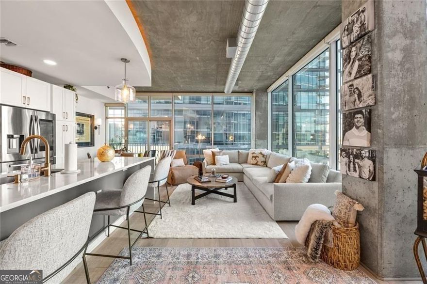 A rare designer residence in the heart of Midtown's skyline. Step into one of Metropolis' most coveted one-bedroom corner homes-an impeccably upgraded space with bespoke finishes, dramatic skyline views, and a rare storage unit. Every surface has been thoughtfully reimagined with a designer's eye for detail, creating a level of sophistication rarely found in high-rise living.  Walls of floor-to-ceiling windows flood the space with natural light, framing Atlanta's iconic skyline. The open-concept kitchen is a showpiece, featuring white shaker cabinetry, a waterfall-edge quartz island, chevron-patterned backsplash, floating wood shelves, and premium stainless steel appliances.  The spa-quality bath offers a frameless glass shower, dual vanity, hex marble tile, and chic gold fixtures, while the bedroom feels like a private retreat with custom drapery, motorized shades, and a spacious walk-in closet. Throughout, wide-plank hardwood floors, curated lighting, and sophisticated textures elevate every detail.  Metropolis is Midtown's premier address, offering a 24-hour concierge, saltwater pool with cabanas, state-of-the-art fitness center, stylish clubroom, multiple outdoor kitchens and firepits, EV charging stations, and a skyline observation deck.  Perfectly located at Peachtree and 8th with a Walk Score of 93, you're steps from Piedmont Park, Colony Square, The Fox Theatre, and Atlanta's best dining and shopping. Minutes to Buckhead, Ponce City Market, and major highways-this is luxury city living, redefined.