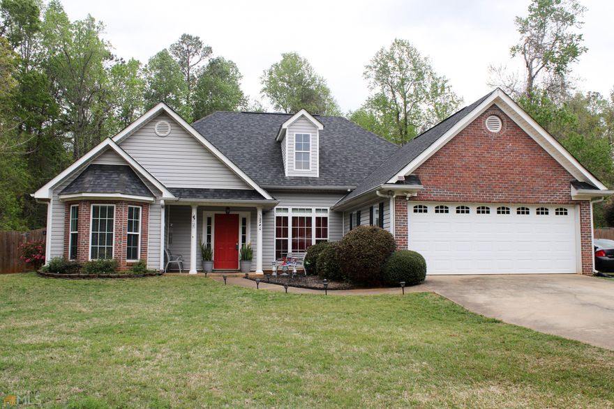 Beautiful 3 bedroom, 2 bath split floor plan home with great curb appeal! Front porch has space for a sitting area and is surrounded by beautiful white columns and flower beds. Walk through the front door into the foyer and be wowed by the high, smooth ceilings, open dining and living area, beautiful decorative molding from floor to ceiling along with hardwood flooring. Great room features a fireplace with gas logs and decorative mantel. You can either access the spacious kitchen through the dining room or great room. Entertaining will be easy with all the counterspace this kitchen has to offer. Beautiful granite countertops, lots of cabinets, pantry, breakfast bar and breakfast area make a great place for anyone to enjoy cooking and baking year-round. Off the kitchen is a hallway that takes you to two guest bedrooms and guest bathroom. Also, off the kitchen is the laundry room with built-in cabinets and access to the garage that is large and offers plenty of built-in cabinets. On the opposite side of the house, you will find the Owner's Suite of your dreams. Walk into a sitting area featuring hardwood floors and a beautiful bay window. Then step into the bedroom and notice the double-tray ceiling and triple window which gives you plenty of natural light coming in. Headed into the large bathroom room, you will notice there is not one but two walk-in closets. Another wow factor is the Owner's Suite bathroom with its vaulted ceiling, two separate vanities with marble tops & sinks, corner soaking tub, separate shower and separate toilet room. Now it's time to head outside to the huge fenced in backyard. French door from Great room leads out onto a patio where you will have plenty of room for sitting & grillin'. The 12X20 workshop is a great place for storage or other creative ideas. It offers a ramp & roll-up door along with a lean-to and a small front porch. This home has one of the largest lots in the neighborhood with a small portion with road frontage on Hammett Rd. It is located in a quiet neighborhood just minutes from downtown, shopping, dining, entertainment, parks, schools, industrial park and the interstate and also gives you access to the community lake. Come home to Eleanor's Pond, grab your fishing pole and enjoy the warm sunny days that are ahead!