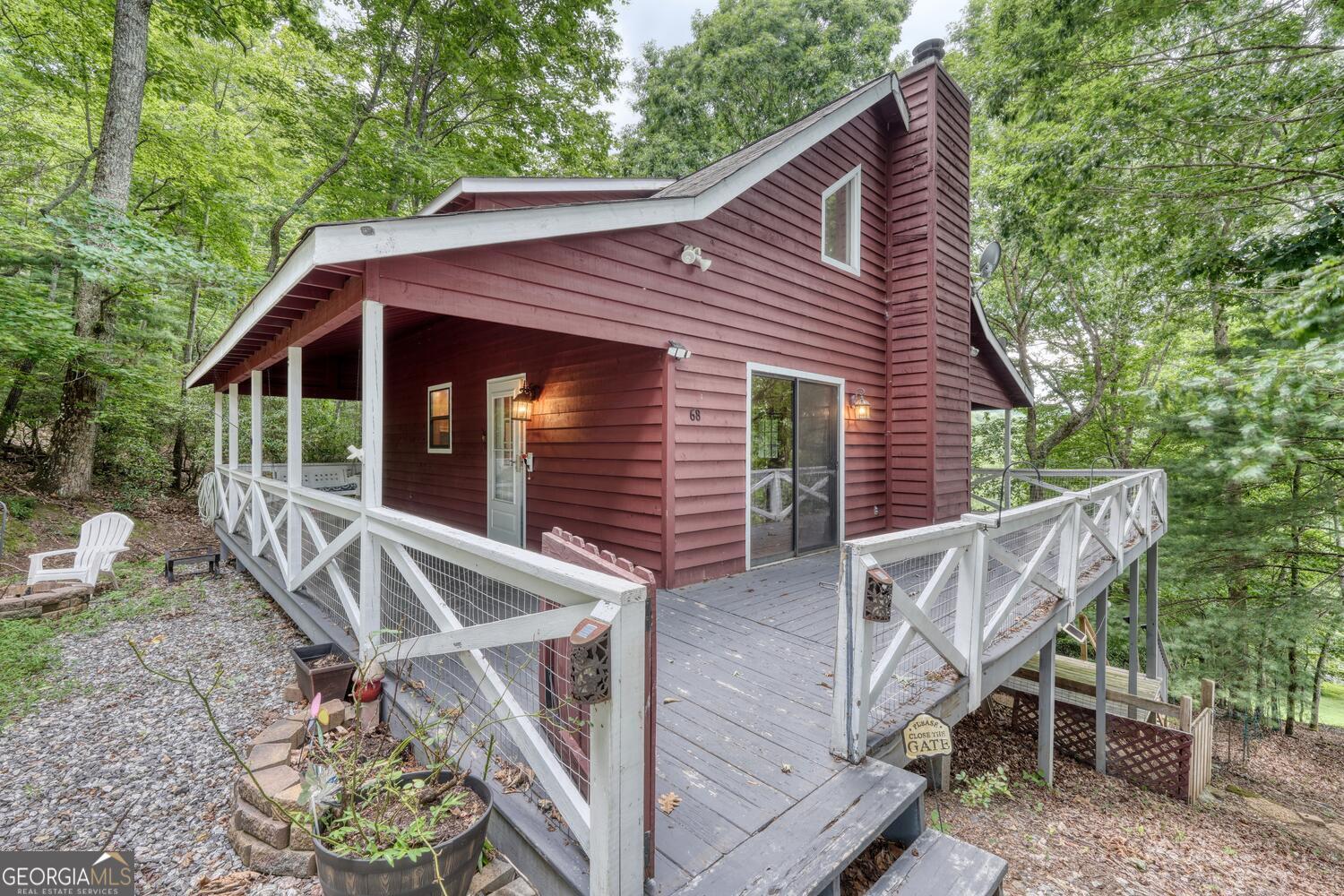 Charming 3 Bedroom, 3 Bath North Georgia Mountain Cabin Retreat! Escape to your perfect mountain getaway with this inviting cabin tucked in the scenic North Georgia mountains, offering stunning year-round mountain views and easy access all year long. This charming home is the ideal blend of rustic warmth and modern comfort, designed for relaxation, recreation, and making unforgettable memories. Step into the cozy living room where wood floors, cathedral ceilings, and a wood-burning fireplace create an atmosphere of warmth and tranquility. The kitchen is beautifully appointed with granite countertops, appliances, and a charming pantry niche that's just right for a vintage Hoosier cabinet or your dream custom coffee bar. The main-level master bedroom provides comfort and privacy with a full bathroom, while the large loft bedroom upstairs features a walk-in closet and its own private full bath. Downstairs, the finished basement offers an additional bedroom with another full bath, a game room or secondary living area, and a laundry space with washer and dryer that's perfect for hosting guests or enjoying family fun. Outside, enjoy a wraparound deck for lounging or dining al fresco while soaking in the breathtaking views. The private yard includes a fire pit area for cozy evenings under the stars, and a storage shed with double doors for your tools, toys, or outdoor gear. Located close to parks, hiking trails, waterfalls, and countless outdoor adventures, this is more than a home-it's your basecamp for mountain living. Whether you're seeking a full-time residence, a vacation escape, or a rental investment, this North Georgia mountain cabin checks all the boxes.