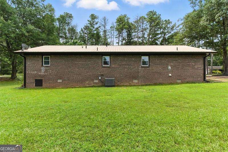Your buyer will be thrilled to find this all Brick Ranch nestled on huge level lot! Totally renovated to include: Plumbing, Electrical, HVAC, Lighting, Flooring, Carpet, Hot Water Heater, stainless Appliances, Sink, Doors, Gutters, additional parking for RV, Windows & screens, Shelving & Thermostat. If you just want to close and move in, this is your opportunity! No HOA just great location as minutes to 61, 75, Lake Pointe Complex, and 113. 3 Bedrooms, 1 bath, lovely kitchen with stainless steel appliances, Hardwood flooring, fabulous countertops. Walk-in Laundry room and extra storage off the Carport. Great room has new ceiling fan, interior paint and Hardwood flooring. All bedrooms have plush carpet and ceiling fans. Primary has walk-in closet. Mature landscaping gives you lovely yard and room for swing set or pool if you desire. Bring the RV or Boat as additional parking adjacent to carport. Great metal roof and new gutters too! Save on your electric bill with new windows with screens too. Septic tank was pumped last year.