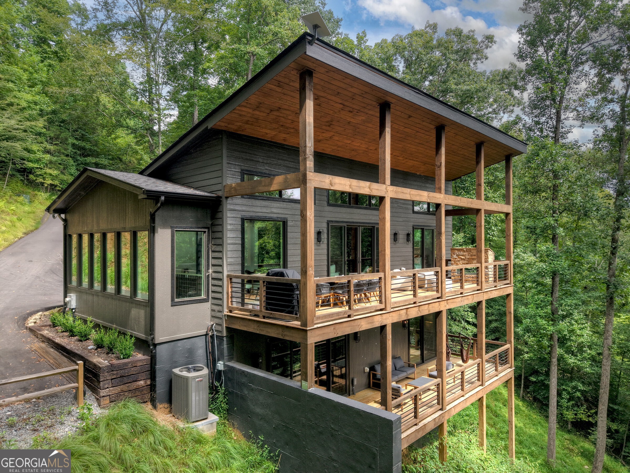 Overlooking the rushing bend of the Toccoa River and basking in the sounds of the rapids below from expansive decks -- welcome to the Toccoa River Chalet! With walls of glass, soaring ceilings, and a contemporary lifestyle blended w/ timeless mountain rustic elements, this new construction retreat less than five minutes to Downtown Blue Ridge is a one-of-a-kind retreat with irreplaceable trophy trout river frontage and year-round mountain and water views! Complete with three full bedroom suites, large open-concept living, kitchen and dining on the main w/ sprawling decks and outdoor space, glass sliders opening the interior of the home to the gorgeous and private outdoor area, full terrace level den, and top of the line finishes throughout! Located in sought-after fully gated Toccoa Preserve, and with a fully paved driveway this home blends in-town convenience all while sitting on an estate-sized riverfront lot. Sold furnished and would make for the perfect full-time, second home or rental investment. Call today!