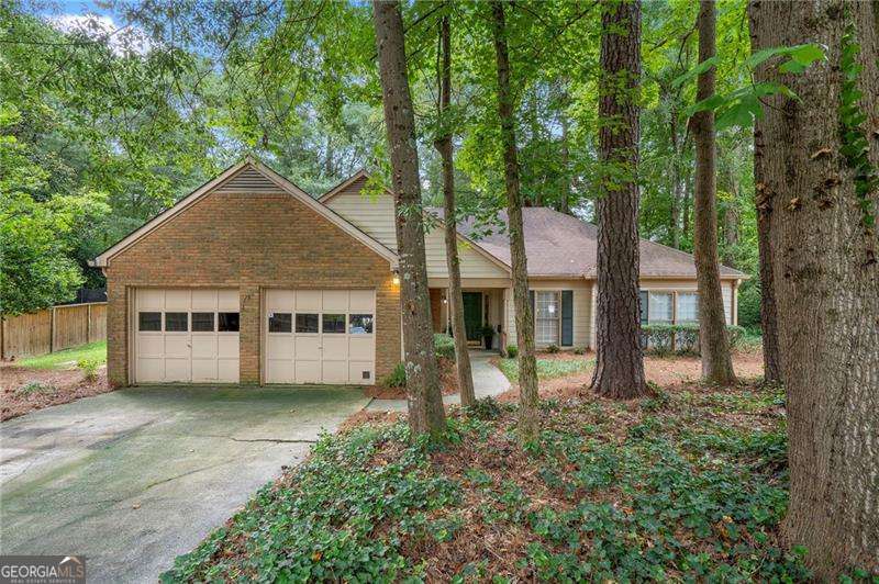 Welcome to this charming ranch-style home nestled on a spacious cul-de-sac lot in the sought-after Mannings Ridge community adjacent to downtown Alpharetta. Lots of potential and ready for your personal touch, this home offers a functional layout and fantastic outdoor space. Step through the covered front entry into a welcoming foyer that flows into a bright kitchen featuring stained cabinetry, white countertops, and a sunlit breakfast nook. A separate dining room is perfect for gatherings, next to the soaring two-story great room with brick fireplace. The primary suite includes a private bath, while two additional bedrooms share a full hall bathroom. Enjoy outdoor living on the covered rear patio, ideal for relaxing or entertaining. Mannings Ridge offers a wonderful lifestyle with neighborhood amenities including a pool, clubhouse, and playground. Best of all, you're just minutes from downtown Alpharetta, Avalon, GA 400, Ameris Bank Amphitheatre, and some of the area's top-rated public and private schools.