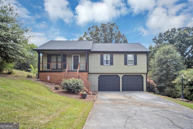Welcome to this charming, well maintained 4-bedroom, 3-bathroom ranch home nestled on nearly an acre of peaceful land. Thoughtfully updated, this home features brand-new LVP flooring, a freshly built deck and front porch, and new garage doors that add both style and convenience. Benefit from the owner's attention to the home with a new roof, new gutters and downspouts and exterior paint. The finished basement expands your living space with a spacious family room, full bathroom, sink, cabinets and mudroom-perfect for gatherings, guests, or a private retreat. Enjoy quiet mornings or evenings outside, surrounded by nature, while still being just a short drive to everyday conveniences. This move-in ready home is a wonderful blend of updates and serene living.
