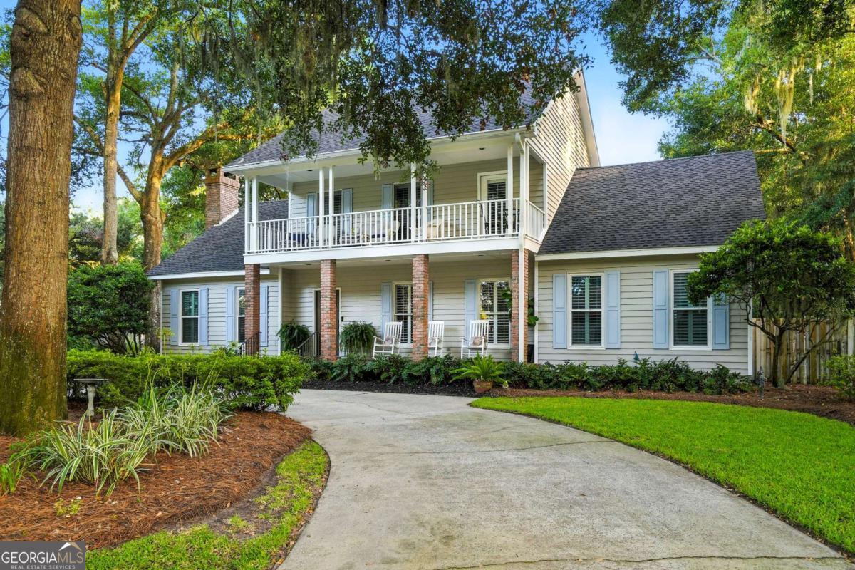 Nestled in the sought-after Vassar Point subdivision, this inviting two-story Southern-style residence seamlessly blends timeless elegance with modern comforts. Built in 1991 with many upgrades and renovations, the home spans approximately 2,827 square feet and is perfectly situated on a beautifully landscaped 0.37-acre corner lot adorned with mature shade trees and a fully fenced backyard. Inside, you'll find 4 bedrooms (including a versatile bonus room that can serve as a fourth bedroom, office, or playroom) and 3.5 tastefully updated bathrooms. The spacious family room features soaring vaulted ceilings, a charming brick gas fireplace, and custom built-in bookcases. Two dining spaces include a formal dining room and a light-filled breakfast area overlooking the pool, flowing seamlessly into a bright, upgraded kitchen complete with a large pantry, gas stovetop, and premium appliances. The oversized primary suite is conveniently located on the main level, offering two walk-in closets and a recently remodeled en-suite bath with double vanities and a walk-in shower. Upstairs, the generously sized bedrooms each enjoy a private bath, providing comfort and privacy for family or guests. The outdoor spaces are equally impressive, featuring a circular driveway, stone walkways, and a spacious Trex deck overlooking a sparkling saltwater pool. The lush backyard includes a firepit area perfect for gatherings. Additional highlights include a two-car garage with a floored attic, a covered carport ideal for a golf cart or additional vehicle, plantation shutters, and refinished hardwood floors. Combining classic architecture with thoughtful updates, this home offers a perfect blend of warmth, style, and functionality-an exceptional retreat in one of the area's most desirable locations.