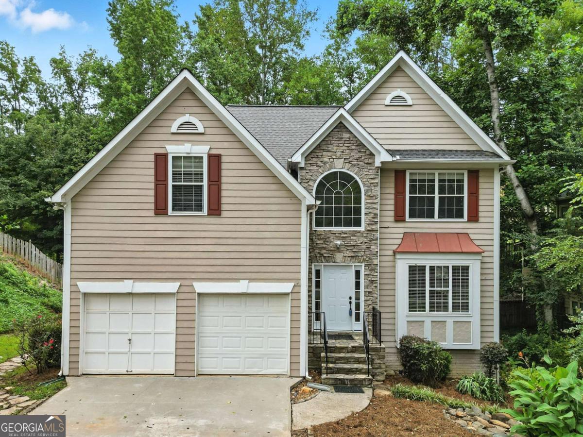 Great value in Towne Lake's Wyngate subdivision! This 4-bedroom, 3.5-bath home offers a spacious fenced backyard and a basement suite ready for finishing touches-just add flooring and a mini split. Features include a living/dining combo, separate family room, updated kitchen with white cabinets, granite counters, breakfast area, new range, and new sliders to the deck. The upstairs master suite has a large walk-in closet, double vanity, and separate tub and shower. Three more bedrooms, one with built-ins, and a full bath. Enjoy the large backyard with firepit, patio, deck, and lots of room to play. Wyngate offers 2 pools, active swim team, clubhouse, tennis, basketball, pickleball, playground, sidewalks, and active social activities. Convenient to Woodstock Downtown, Lake Allatoona, and all the shops and restaurants in Towne Lake.