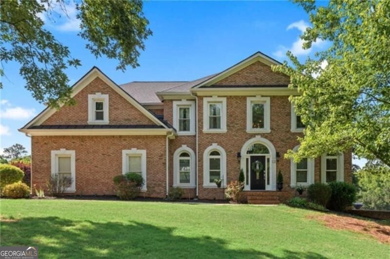 Nestled on 8 serene acres, this three-sided brick estate offers the perfect balance of luxury living and equestrian lifestyle. Ideal for horse enthusiasts, it features a two-stall barn with water and electricity, a welcoming paddock, and a 110' x 80' riding arena with 4" deep, footed sand. The barn also includes an RV hookup, power for a hot walker in the paddock with a lean-to shelter, a wash rack, and concrete floors in both the barn aisle and wash rack. You'll find tons of storage inside, plus two enclosed lean-tos for additional storage. The barn can easily be configured for a third stall or washroom, making it fully adaptable to your needs. Most of the property is fenced in lush pasture with four-board fencing, plus a separate fenced area for dogs. Inside, a grand two-story foyer opens to hardwood floors throughout the main living spaces. The main level boasts a private guest suite with full bath, an exquisite chef's kitchen with large island, perfect for entertaining and open to a dramatic two-story great room with floor-to-ceiling windows. Enjoy gatherings in the bright breakfast room/sunroom with sweeping pasture views. A formal living room (ideal for an office) and a separate formal dining room complete the main floor. Upstairs, the oversized owner's retreat showcases a brand-new, beautifully renovated spa-style bath, his/hers closets, and a flex room perfect for a home office, nursery, or gym. Three additional spacious bedrooms, including one with a private en-suite, plus a newly updated hall bath, offer plenty of space for family and guests. The finished terrace level offers endless possibilities....rec room, media space, gym/office, custom bar, full bath, and a second laundry room already plumbed for a kitchen, making it ideal for an in-law suite. It also includes a third-car garage with ample space for a boat, lawn equipment, or workshop. Outdoor living shines with a sparkling in-ground saltwater pool, expansive sun patio, and panoramic views of the rolling landscape...your own private oasis! Recent updates include new windows, new roof, and top-of-the-line HVAC. Zoned A1, this property welcomes all your animals! Just minutes from Silver Comet horseback riding trails, 45 minutes to the Atlanta Airport, and convenient to Hwy 278, Wellstar Medical Center, shopping, dining, and schools. With its blend of privacy, elegance, and equestrian amenities, this property delivers a truly rare lifestyle opportunity.