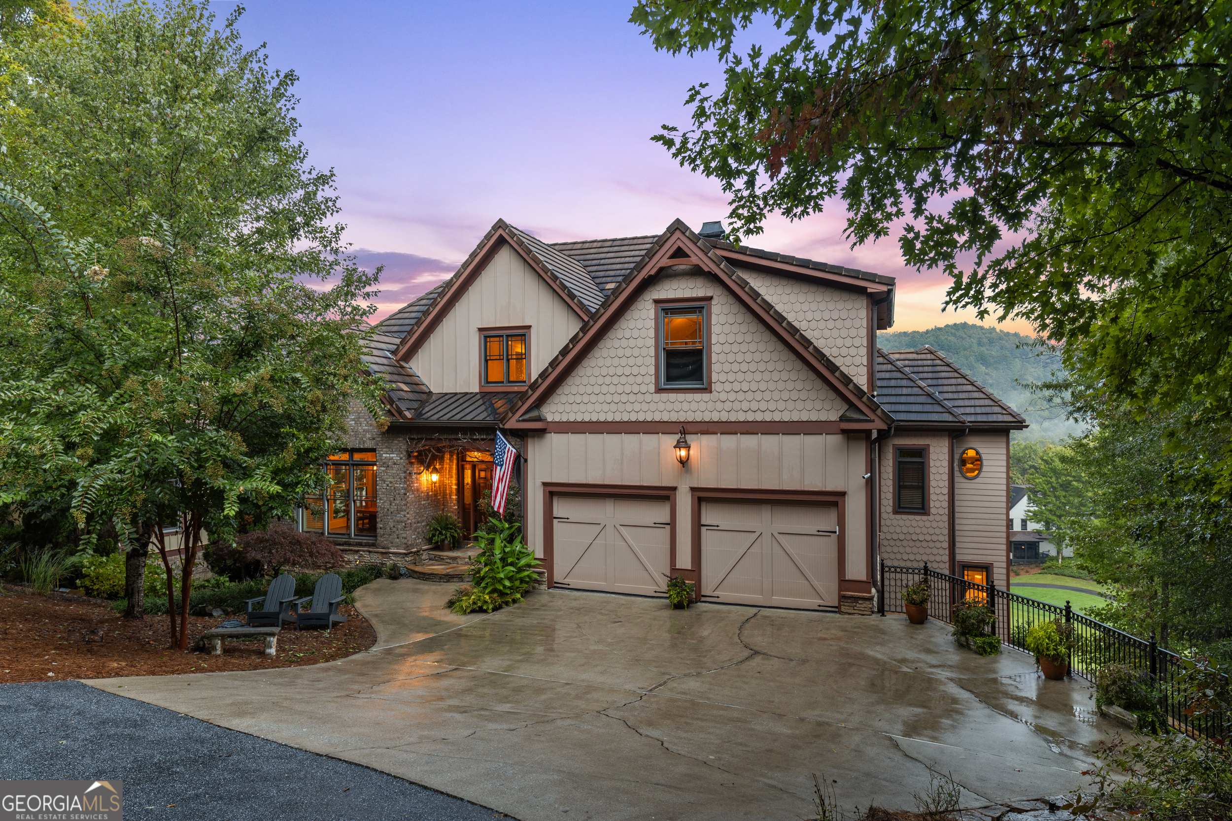 Nestled along the scenic 5th fairway of the exclusive and coveted Waterfall at Lake Burton Golf Community, this luxurious 5-bedroom, 5.5-bath home offers a unique blend of elegance, comfort, and a truly idyllic setting. Step out on to either of the two large, covered porches and enjoy watching golfers perfect their swing on the most challenging number 5 hole with creek and pond views. This beautiful custom-built Craftsman-style home design features rich wood accents, soaring floor to ceiling 2 story rock fireplace with gas logs, and an open-concept living space ideal for entertaining. The gourmet kitchen boasts high-end stainless-steel appliances, granite countertops and load of cabinetry-perfect for culinary enthusiasts to entertain family & friends either in the spacious adjoining dining room, easily seating 12, or the casual breakfast room by the upper covered porch with tv, and ceiling fans. The primary suite is conveniently located on the main level, offering a private retreat with beautiful views of the golf course & adjacent mountains. Upstairs there are two generously sized bedrooms, each with their own en-suite bath & walk in closets. The recently finished terrace level adds incredible versatility with two additional spacious bedrooms, a micro kitchen, another living area, and office making it ideal for an in-law suite or guest quarters. And do not miss the infrared sauna in the unfinished storage space! Conveniently located less than 12 minutes from the charming town of Clayton with all the farm to table restaurants, boutiques, galleries and so much more. For the outdoor enthusiast, you are within 5 minutes to the pristine waters of Lake Burton, minutes to 3 state parks with hiking, waterfalls and fishing galore, as well as horseback riding, biking, zip lines and so much more. Whether you're seeking a full-time residence in a secure community or a rich, rustic mountain getaway, this home is it - combining warmth, functionality, and location in one unforgettable package.