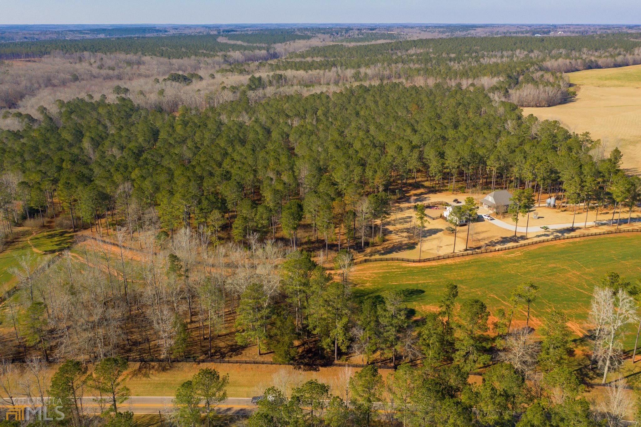 Location Found in the gently rolling countryside of western Morgan County, GA - Fortlin Farm offers a rural retreat located within an hour of Athens, Milledgeville & Downtown Atlanta. Historic downtown Madison is within minutes offering nearby convenience of the local shops and restaurants and Lake Oconee is just 20 minutes away. Major corporate investments in the immediate area have accelerated economic growth in the area - with Facebook's recently opened Newton Data Center and Rivian's $5 Billion Dollar facility under development both within 10 miles of the property. Property The current steward of Fortlin Farm has spent 10 years assembling neighboring properties to develop a turn-key recreational estate which has been intensively managed for deer, turkey and ducks. The +/- 320 fenced acres features established food plots scattered through the property with sawtooth oaks and fruit trees planted to provide prime deer habitat. The internal network of roads and trails provide access throughout the property from the paved road frontages and multiple gated entrances on Clack Road and Weaver Jones Road. Pole Creek meanders through the property with a stocked two acre pond offering prime fishing for catfish and large mouth & hybrid bass and the beaver ponds providing great duck habitat. Improvements Designed as a comfortable farm retreat for family and friends - the two bedroom main home is well appointed for an extended stay - and the nearby barn offers additional accommodations along with a kitchen and living area above.