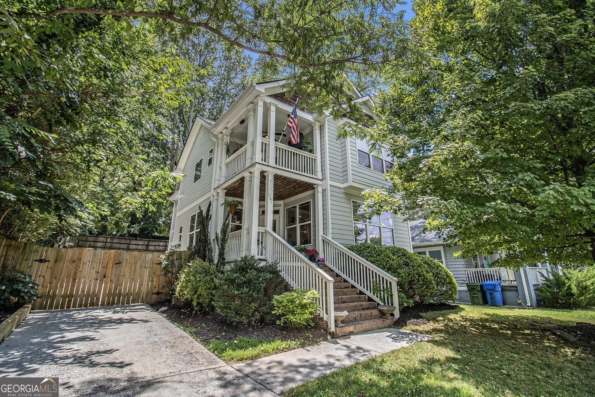 Step into this charming Craftsman-style retreat, where classic charm meets modern comfort and a vibrant community lifestyle. As you enter, you're welcomed by an open-concept main level adorned with rich hardwood floors, perfect for both everyday living and entertaining. The inviting living room features a cozy fireplace-lots of light and ideal for relaxing evenings with friends or curling up with a book. The kitchen is easy for a cook to work his/her chef magic as everything is close and easy to function with the amount of granite countertop space, stainless steel appliances, and a convenient breakfast bar that makes casual meals and morning coffee a breeze. Easy access to the 2 car garage with extra storage space, just off the hall at the kitchen level. Upstairs, the spacious primary suite is a true sanctuary, complete with vaulted ceilings, a walk-in closet which provides generous storage, ensuring your space remains organized and clutter-free, and a private covered balcony-your personal perch to sip coffee or unwind as the sun sets. The luxurious primary bathroom features a classic clawfoot tub and a separate glass and tiled shower The large double sink vanity provide great storage for each side. A secondary bathroom with a tub-shower combo is just down the hall, perfect for guests or family. The 2 secondary bedrooms are spacious and have lots to offer. The home also includes a privacy fence from the street to the extra large two-car garage which provides plenty of space for both vehicles and extra storage. Step outside the garage onto the patio and up a few steps to the long wood deck. This takes you into your private, fenced-in backyard-Weekend barbecues, morning yoga, or letting pets play freely is all at your fingertips here. With fresh interior and exterior paint, plus a newer roof and gutters, this home is truly move-in ready. And best of all, you're just minutes from the energy of the Atlanta BeltLine-enjoy morning jogs or bike rides through nearby parks, pop into eclectic shops, or meet friends for drinks and dining at one of the many vibrant local spots. Whether you crave peace at home or the pulse of the city, this home offers the best of both worlds.