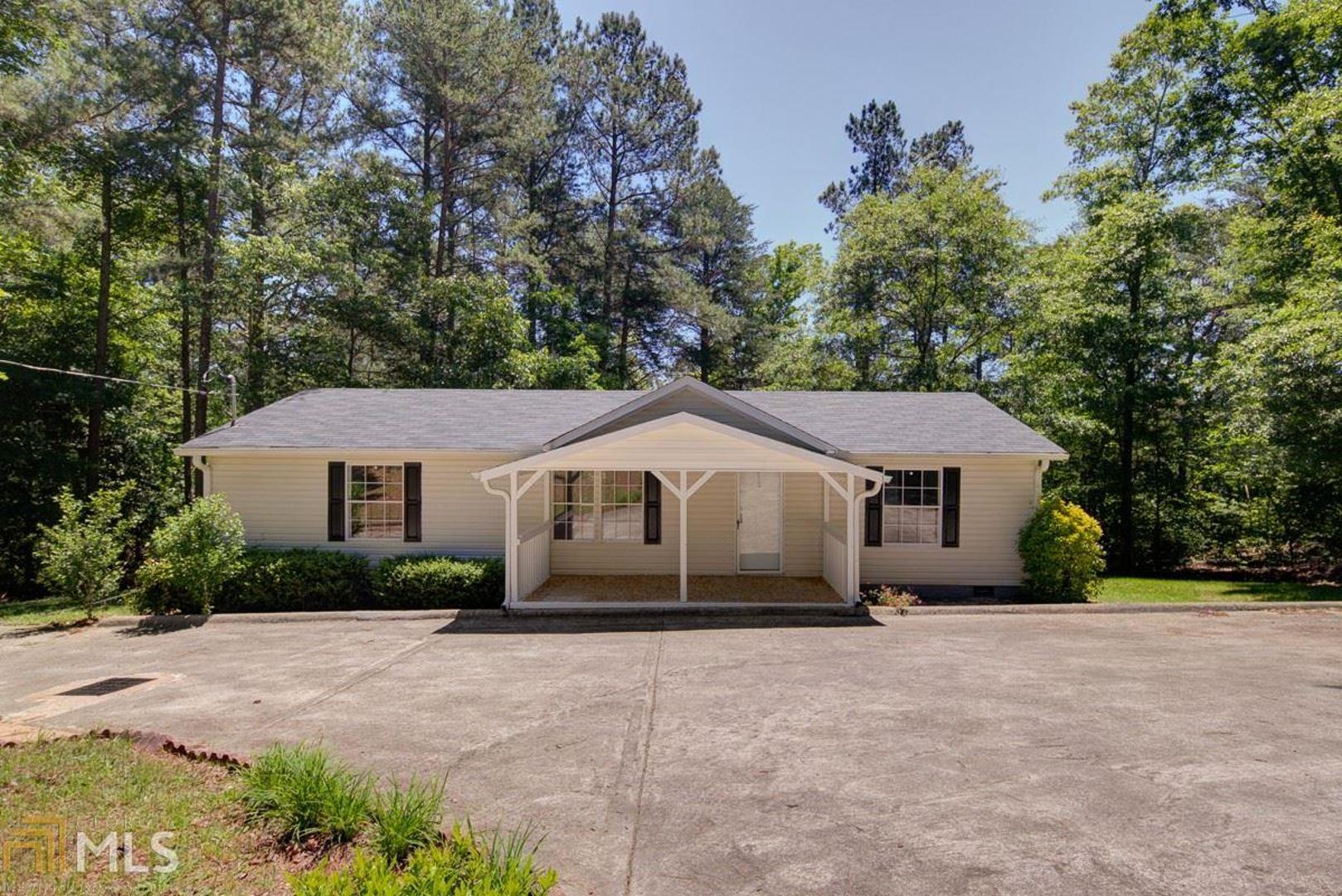 NEWLY RENOVATED 3 bed / 2 bath home featuring an open floor plan, hardwood floors throughout, a large living room, dining area, laundry room, split bedroom plan, and a kitchen with lots of cabinets and counterspace. The level driveway provides ample parking. Home sits on an acre of land with a sloped backyard, an outbuilding, and a covered front porch. Call before it's gone!