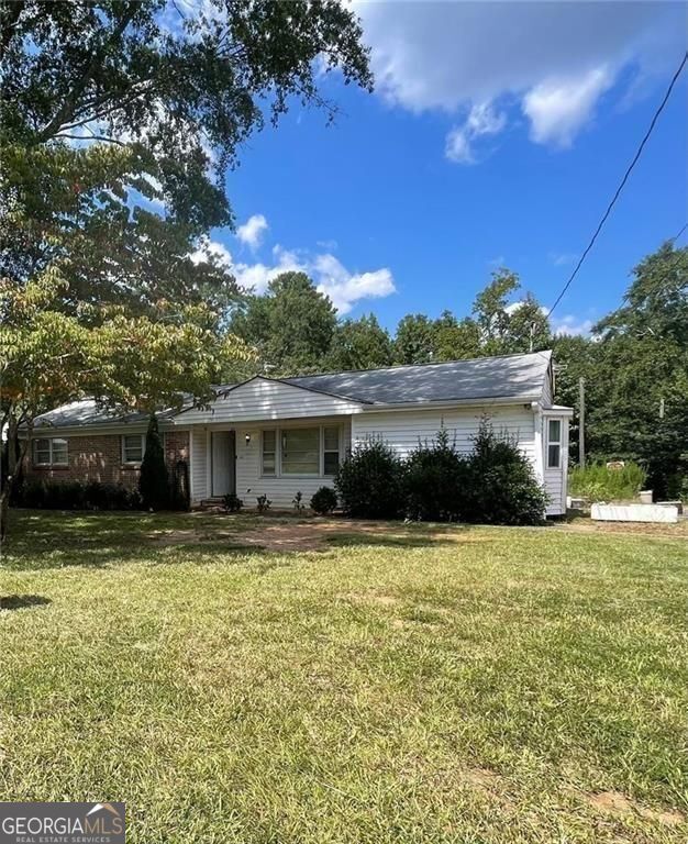 This 3-bedroom, 2-bath home is full of potential and set on a spacious 1.577-acre-lot, an acre larger than neighboring properties. Whether you're looking for a peaceful place to call home or a great investment opportunity, this property has the space and features to make it truly special. Recent updates include a new roof, new HVAC system, and new updated plumbing, giving you a strong head start. The home has great bones and is ready for someone to bring it to life. Property includes outbuildings and a large workshop with it's own HVAC and plumbing, perfect for storage, hobbies, or future projects. A creek runs along the back of the lot, adding natural charm. With room to expand and a unique setting, this home is a rare find with endless possibilities.
