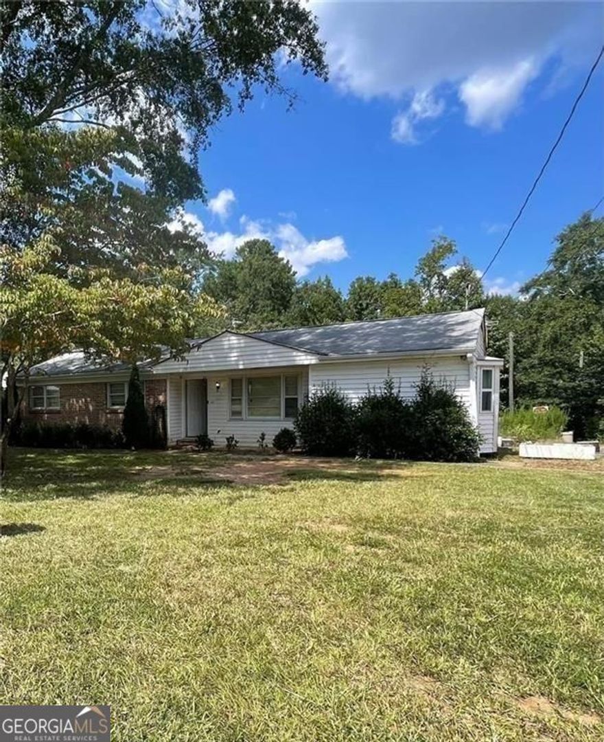 This 3-bedroom, 2-bath home is full of potential and set on a spacious 1.577-acre-lot, an acre larger than neighboring properties. Whether you're looking for a peaceful place to call home or a great investment opportunity, this property has the space and features to make it truly special. Recent updates include a new roof, new HVAC system, and new updated plumbing, giving you a strong head start. The home has great bones and is ready for someone to bring it to life. Property includes outbuildings and a large workshop with it's own HVAC and plumbing, perfect for storage, hobbies, or future projects. A creek runs along the back of the lot, adding natural charm. With room to expand and a unique setting, this home is a rare find with endless possibilities.
