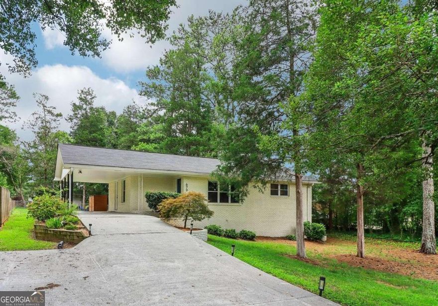 This beautifully renovated 3-bedroom, 1.5-bath brick ranch in desirable Powers Park is just 10 minutes from the Battery at Truist Park, Marietta Square, Kennesaw State Marietta campus, and the Chattahoochee Recreation Area. Nestled in a quiet community, it offers easy access to top-rated East Cobb schools and scenic walks along the Chattahoochee River. Inside, enjoy a fully remodeled kitchen with new appliances, a new half bath, updated lighting, and a refreshed full bathroom. The spacious 800-squarefoot daylight basement is perfect for additional living or storage. The level, fenced backyard features shade trees and a fire pit, ideal for evenings outside. A convenient carport fits large SUVs, making grocery unloading a breeze. With a brand-new roof and fresh exterior paint, this home combines modern comfort with the charm of an established neighborhood, complete with mature trees and long-time neighbors.