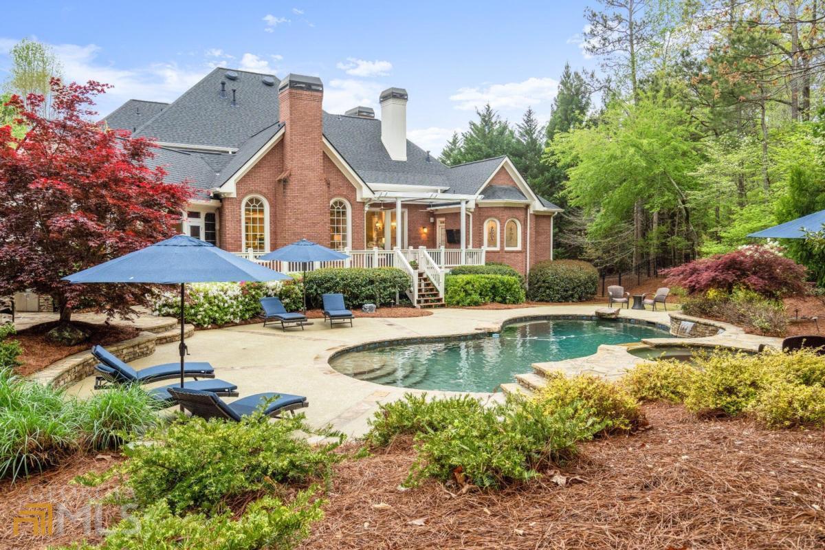 GORGEOUS BRICK CUL DE SAC HOME WITH OWNERS SUITE ON MAIN, FINISHED TERRACE LEVEL AND POOL AND SPA IN THE PRESTIGIOUS GATED SECTION OF WHITE COLUMNS. Occupied by the original owners this home has been meticulously maintained and upgraded over the years, including a brand new roof, 4 new A/C units and newer water heater, as well as recent updates to kitchen and owners bath. The backyard has a resort-like feel centered around a gunite Pebble Tec pool with a spa, waterfall, and several additional sheer descents. Solo swim or pool party, youall be ready with outdoor spaces that include a kitchen with a built-in grill and Green Egg, an oversized deck partially covered by a motorized louvered pergola a close it to protect yourself from the rain, open it to let the sunshine in! a and a screened porch with EZ Breeze three-season windows. All of that, and thereas still plenty of yard space for a four-legged friend or a game of kickball. Interior highlights include a recently renovated kitchen featuring quartz countertops, painted cabinetry, and Wolf and Dacor appliances. It overlooks the vaulted keeping room with a fireplace, pool views, and a wood-clad cathedral ceiling. The generously sized primary suite has a fireplace, a walk-in closet with custom organizers, and a recently updated en suite bath with new cabinetry, new countertops, new lighting, a free-standing tub, and a shower with a rain head. It also has a private door to the covered deck. This home is perfect for lavish parties as well as intimate gatherings. There are both informal and formal dining spaces, a large formal living room with windows overlooking the beautiful backyard. If you work from home, a handsome office is located just off the foyer outfitted with judgeas paneling, cabinetry, and bookcases in rich wood tones. Located on the terrace level are a guest suite, workout room, media room, and a game room with a custom bar. On the upper level are three bedrooms, each with a walk-in closet and full bath. On this level, youall also find a large niche perfect for use as a homework station, play space, or household office. The community is conveniently located near top educational options including Cambridge High School as well as Blessed Trinity and Kingas Ridge private schools. Shopping and dining in Milton and Alpharetta are both within an easy drive. But why leave? White Columns is noted as having one of the best golf courses in the area. Tennis, swimming, fitness, and on-site dining are just some of the other amenities offered. The country club lifestyle is calling. Be the first to answer because this home will be gone before you know it.