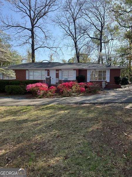 Investors Dream Opportunity! Large double lot! Potential commercial for front half of lot on Canton Road, and possible residential lot on back half of lot with access to quiet Centerview Drive. This unique opportunity has a brick ranch home on front half of lot that has excellent visibility to approx 25,000 cars passing daily on Canton Road. Would make a great office space for any business, or keep long time renter in place for easy income producing. One of the great features of this lot is the easy access from Canton Road but also easy exit via Red Oak Drive to Centerview Dr. Allowing safe and easy traffic flow for everyone. With the back half of this large parcel being a level wooded lot in the residential community of Noonday, you could build a spec home or another rental property. So many options. Best of all the existing home is a well maintained brick ranch with original hardwood floors. In 2019 Seller replaced all waterlines with copper, HVAC, Furnace, roof, and water heater. Home is bigger then tax records reflect with 2 car carport converted to a large family room with bay window and bookcases as well as a huge laundry room. This area could easily be converted to a nice primary suite with private bath to create a 4 bedroom 2 bath home....again, so many options in a fantastic location! Easy access to I-575 and I-75. Close to shopping and schools. Convenient to Marietta Sq. Located in a booming area with lots of great longtime businesses around. Don't miss out on this special opportunity!