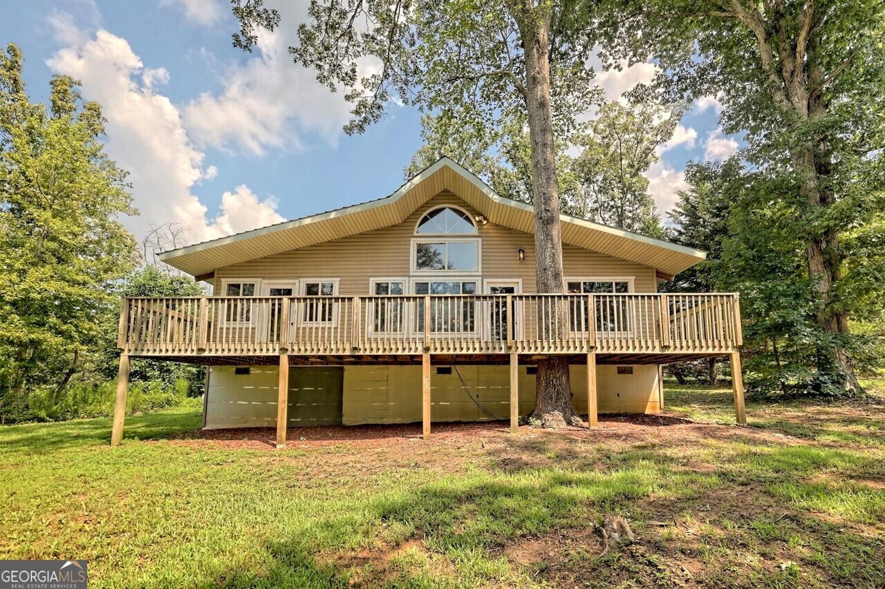 CHARMING UNIQUE COTTAGE ON 2.69 UNRESTRICTED ACRES... Located in a quiet setting off the beaten path and only minutes from Hwy 441/365 for the commuter and a short drive to Downtown Clarkesville for all your shopping, dining, and entertainment needs. This home also features a cozy family room with hardwood floors, tongue and groove ceilings, exposed beams with a highly desired open concept design with a loft. The main level flows nicely to a super functional kitchen with island breakfast bar and abundance of cabinetry for storage. Easy access to a large back deck for grilling out and entertaining guests.