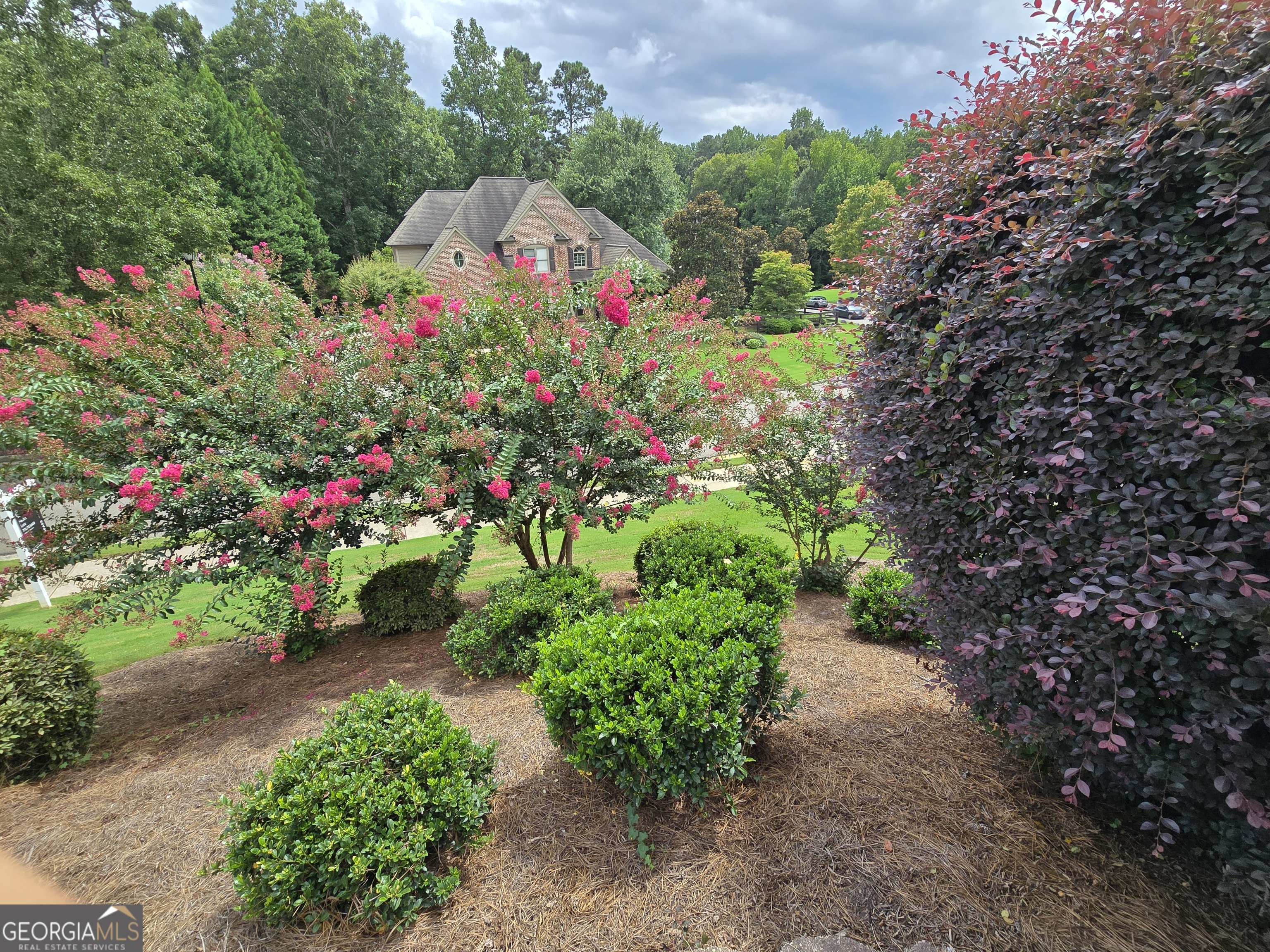 Welcome to this beautiful Alpharetta home, set on a landscaped corner lot in a quiet cul-de-sac next to The Manor Golf & Country Club. With classic brick curb appeal, mature trees, and a timeless exterior, it makes a great first impression. Inside, large windows fill the home with natural light, highlighting high ceilings and open spaces made for both comfortable living and entertaining. There's a bright two-story great room, a chef's kitchen with quality finishes, and a finished terrace level with its own entrance-perfect for guests, multigenerational living, or working from home. Upstairs, the primary suite is a relaxing place to unwind. A three-car garage provides plenty of space for vehicles, hobbies, or a workshop. Outside, a private deck overlooks the spacious, quiet, level backyard with mature landscaping for extra privacy. The covered porch offers a quiet spot to enjoy, and could be expanded into a sunroom or even a whirlpool area for year-round use. Whether you're enjoying morning coffee or evenings under the stars, the indoor-outdoor layout works beautifully. The location is hard to beat, with quick access to GA 400, top-rated schools, parks, shopping, and dining all nearby.