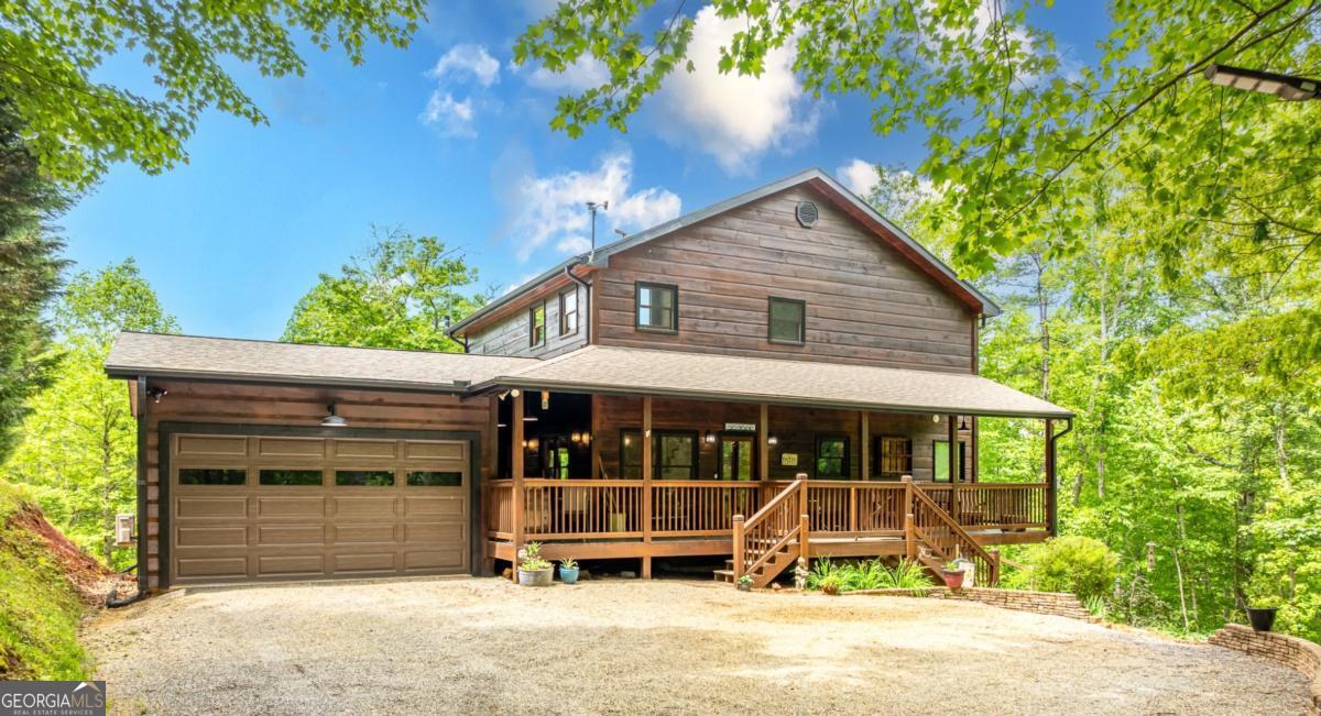 Welcome to your dream escape in the coveted Aska Adventure Area-perfectly positioned near National Forest, Toccoa River, Lake Blue Ridge & miles of hiking & biking trails. This spacious 3 BR/3BA + Loft mountain home is thoughtfully designed with a Bed & Bath on each level, offering the ideal layout for full-time living, multi-generational use, or as a vacation rental. The open-concept main level welcomes you with a seamless flow from the dining area into a well-appointed kitchen featuring abundant cabinetry, an angled island & upgraded stainless steel appliances. Soaring ceilings, walls of windows & striking floor-to-ceiling stacked stone gas fireplace anchor the inviting great room that has French doors opening to an expansive screened porch with outstanding winter mountain views & just imagine the year round views with a bit of tree trimming! The main-level oversized master is a true retreat, complete w/porch access, dual vanities, jetted tub, walk-in tiled shower & a convenient laundry closet tucked inside the ensuite. Upstairs, a spacious loft overlooks a dramatic wall of windows w/awesome mountain scenery, making it the perfect space for an office or relaxation spot. A 2nd large master suite offers a full ensuite bath + private access to a covered porch w/breathtaking mountain views perfect to enjoy your morning drink. The terrace level is made for entertaining w/soaring ceilings, game room w/pool table & bar setup & walk-out access to a covered patio & custom firepit. A 3rd large bedroom, full bath & even more storage make this level ideal for guests or family. Set on a generous 1.77AC lot, the property also has a fenced yard & gated porches for your pets + an insulated, oversized 1-car garage w/mini-split perfect for a workshop or outdoor gear storage. Tons of recent updates including newer roof, AC units, tankless water heater & more. With a versatile layout, scenic setting & upscale rustic charm, this house is your ultimate mountain home, getaway, or STR.