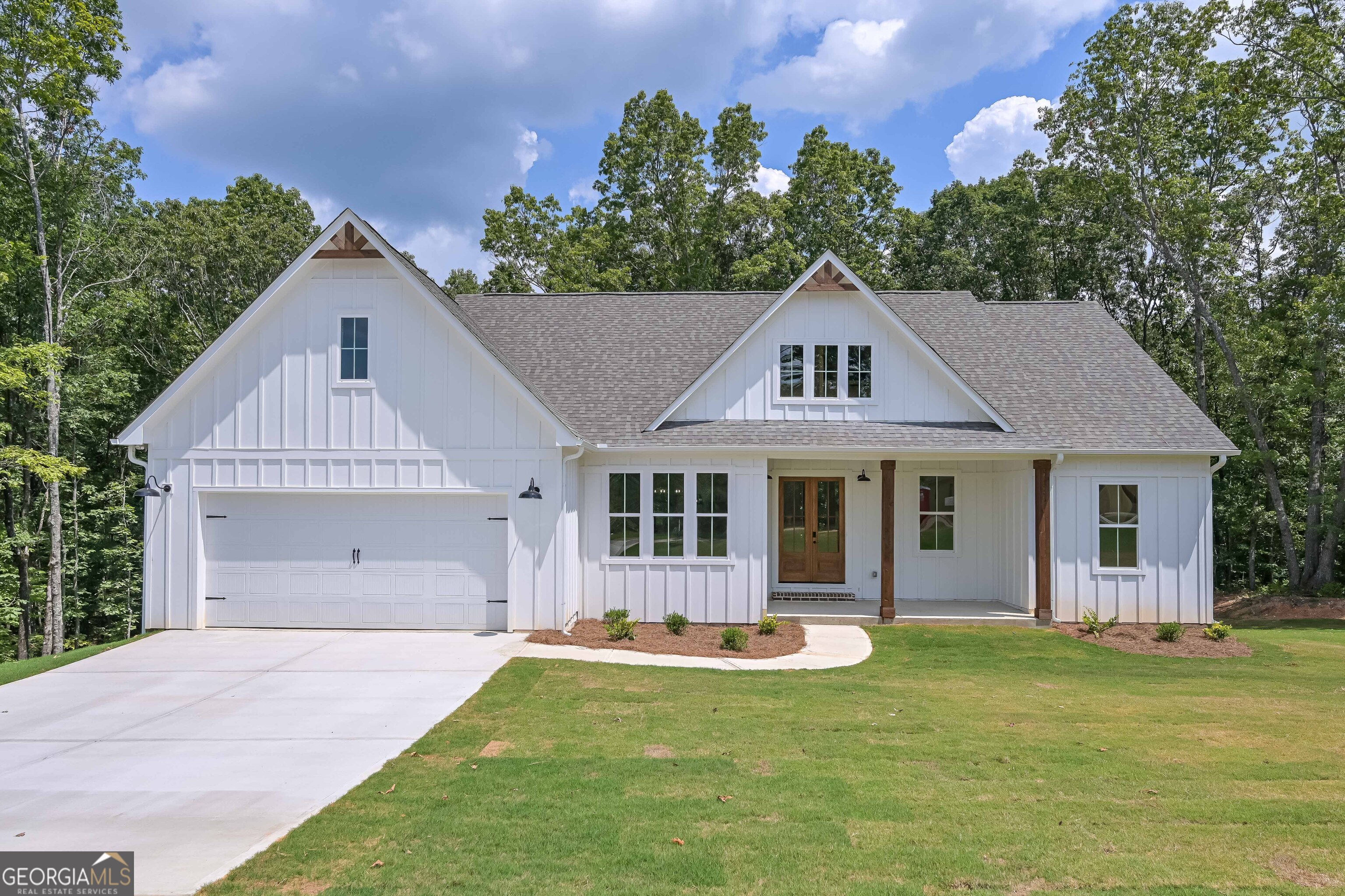Welcome to this stunning farmhouse-style ranch home with an unfinished basement, perfectly situated on a spacious one-acre lot in the highly sought out community of The Oaks at Five Points. This beautifully designed home offers 3 bedrooms, 2 full bathrooms, and a dedicated office, making it perfect for both comfortable living and working from home. As you step inside, you'll be greeted by an open-concept layout filled with natural light and modern charm. Unique details include black interior doors and finishes, beamed ceilings in the dining room, stylish sliding barn doors, and more. The kitchen is a true showstopper, featuring a large white quartz island, ideal for entertaining or gathering with family and friends. Just off the kitchen, step onto the expansive covered back deck, complete with two sleek black ceiling fans to keep you cool during warm summer days. The private master suite is thoughtfully separated from the secondary bedrooms and includes a bathroom with dual vanities, a tiled shower with two separate showerheads, a large soaking tub, and a generously sized walk-in closet. The laundry room is conveniently located just off the master suite for added ease. The unfinished basement offers incredible potential with endless possibilities - whether you envision a home theater, gym, or additional living space. With ample storage throughout, a large backyard perfect for entertaining, and stylish features inside and out, this home blends farmhouse charm with modern convenience. This home is a MUST SEE!!