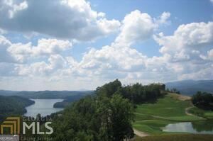 Stunning lot offering a stupendous view of layered mountains and the beautiful Lake Burton. Nestled on a quiet dead-end street, enjoy the peace and privacy of no through traffic. The amazing offer price provides incredible value in this premier location. While the minimum square footage to build is 2,500 sq ft, the topography of the lot allows for a larger home design to maximize the breathtaking scenery. Located in an exclusive gated community overlooking Lake Burton, ownthat is home to the renowned Waterfall Club, offering exceptional amenities and a luxury lifestyle. This is a rare opportunity to own a piece of mountain-lake paradise!
