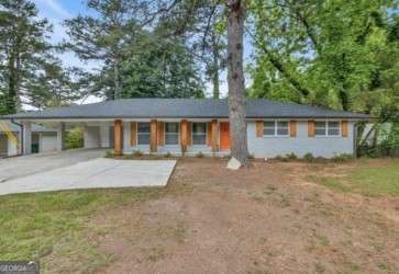 Discover this beautifully updated 3-bedroom, 2-bath traditional brick ranch, recently operated as a successful Airbnb. Inside, you'll find an inviting modern open concept living area that flows seamlessly into a stylish kitchen featuring soft-close white shaker cabinets, an oversized island, granite countertops, and modern design. This move-in ready home perfectly blends classic charm with modern comfort.