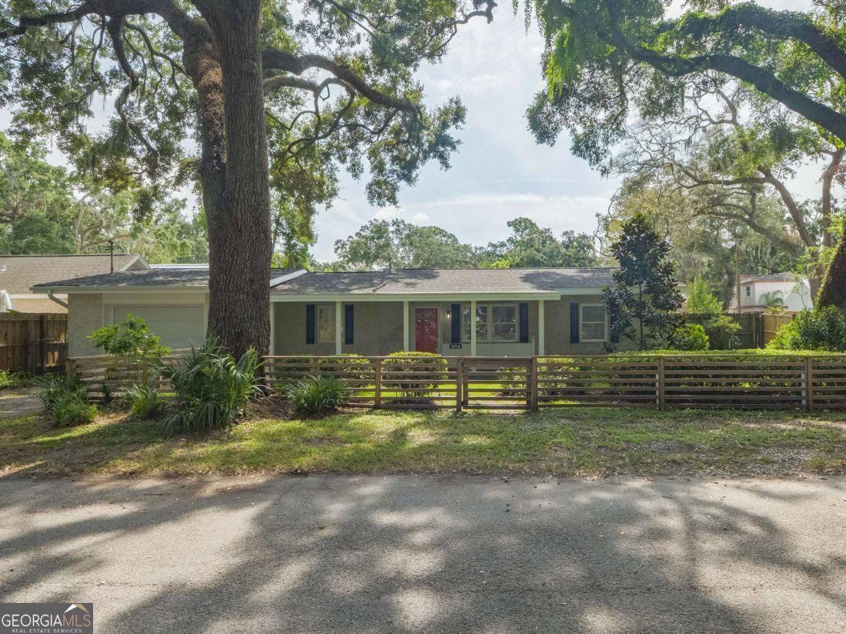 There's something special about this one-and you feel it the moment you step inside. 204 4th Avenue is more than a full renovation on a quiet, oak-canopied street on desirab;e mid St. Simons Island. It's a home that's been thoughtfully reimagined by artists-where every detail, from the flowing open floor plan to the curated light fixtures and finishes, reflects a sense of creativity and care. Built solid-literally-with full concrete block construction, this home offers the kind of lasting strength and insulation that's hard to come by. Inside, walls have been opened to expand the footprint and create seamless flow between the living spaces and the outdoors. The expanded chef's kitchen is a showpiece, complete with a dramatic custom LG HIMACS artic white countertop on the waterfall island, farmhouse apron sink, new cabinetry, and all-new stainless-steel appliances. Cali Aqua Tough floors run throughout-durable, waterproof, and soft underfoot-with a quiet sound pad that adds warmth and comfort. A newly added back door leads to a fully fenced and freshly sodded backyard, shaded by mature oaks and perfect for private gatherings or peaceful mornings. The double lot offers space to stretch out-whether on the back patio, the wide side yard, or the welcoming front porch. The home also includes a 450 sq ft attached garage not reflected in the official square footage-ideal for storage, studio space, or future expansion. Other updates include: double-pane windows, new bathroom vanity and lighting, updated contemporary fixtures, a 2018 roof and HVAC system, fresh interior paint, professional landscaping, and oak tree maintenance completed in April 2024. This isn't just a home-it's a space that inspires. If you're looking for something with character, function, and a quiet touch of artistry, 204 4th Avenue is waiting to be experienced.