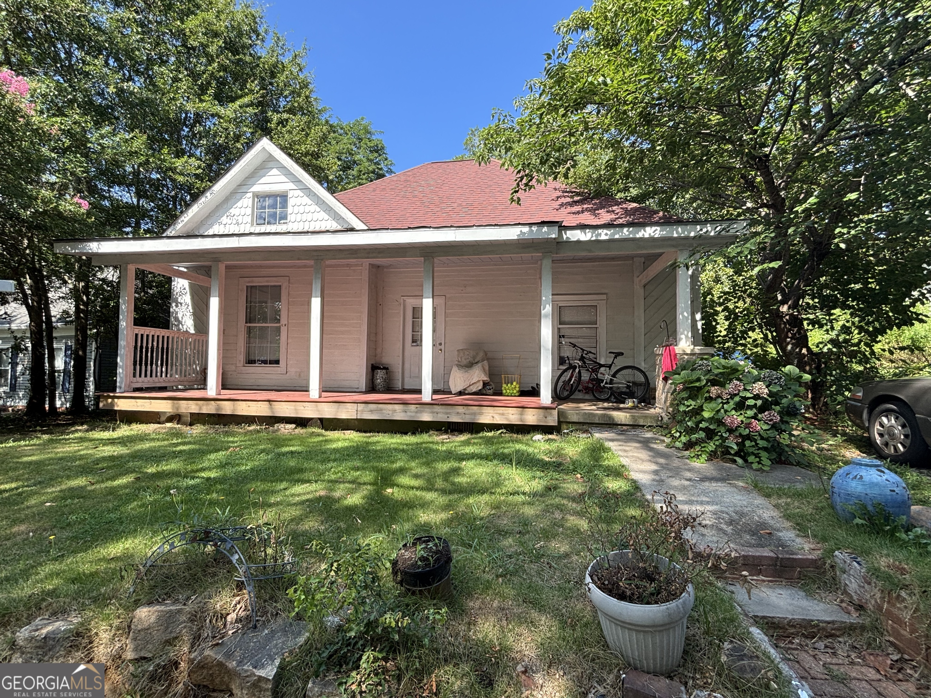 FANTASTIC PRICE for this historic home with updates and loads of character. Located in the heart of HISTORIC STONE MOUNTAIN VILLAGE and the famous, world-renowned STONE MOUNTAIN PARK. The home features a rocking chair-covered front porch- ideal for that early morning coffee or evening refreshment. Walk into the oversized living room, which features the original built-in antique fireplace and hardwood floors. Glass doors separate the living room from the family, dining, and kitchen areas. The kitchen features a wet bar, the original antique sink, plus a quartz cooktop prep island and sink. View the private backyard through the picture window while preparing your family's meals. Enjoy the wall oven, dishwasher, stove, microwave, and the abundance of cabinets; enjoy decorating the unique built-in bookcases. Open the French doors to the side yard. The front and middle bedrooms also feature the original antique fireplaces. The front bedroom has a private bathroom. Again, walk to the Village of Stone Mountain and enjoy the many restaurants, shops, and social events throughout the year. Or, venture to Stone Mountain Park where you can golf, hike, bike, camp, canoe, fish, picnic, kayak, zip-line, walk up, or take the skylift to the top of the mountain, plus much more. Be entertained year-round with all the activities, events, and festivals-never be bored as there is always something to do! Pre-qual, POF must be attached to the offer. The Seller will not entertain any blind offers, owner financing or flips. Once the showing is confirmed, the Seller will place the SUPRA outside the front door
