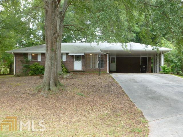 ALL BRICK RANCH home conveniently located within walking distance to shopping, schools, restaurants, & bus line, situated on a corner lot. Clean, neat & taken care of, 3 bedrooms w/ closets, 1 full bath, & 1 half bath. Hardwood floors in bedrooms, may have hardwoods under carpeted areas. Kitchen is open with room for an dinning area. Separate living room just off the kitchen and a separate area off kitchen that could be used for separate dinning room, den, study, office area, etc. makes for an open space to entertain. Just off of the kitchen you have a screened in back porch within a fenced back yard with large oak trees for shade. A great place to have the cook outs & bar b que. Covered carport holds 2 cars. Laundry closet is located in the full bath.