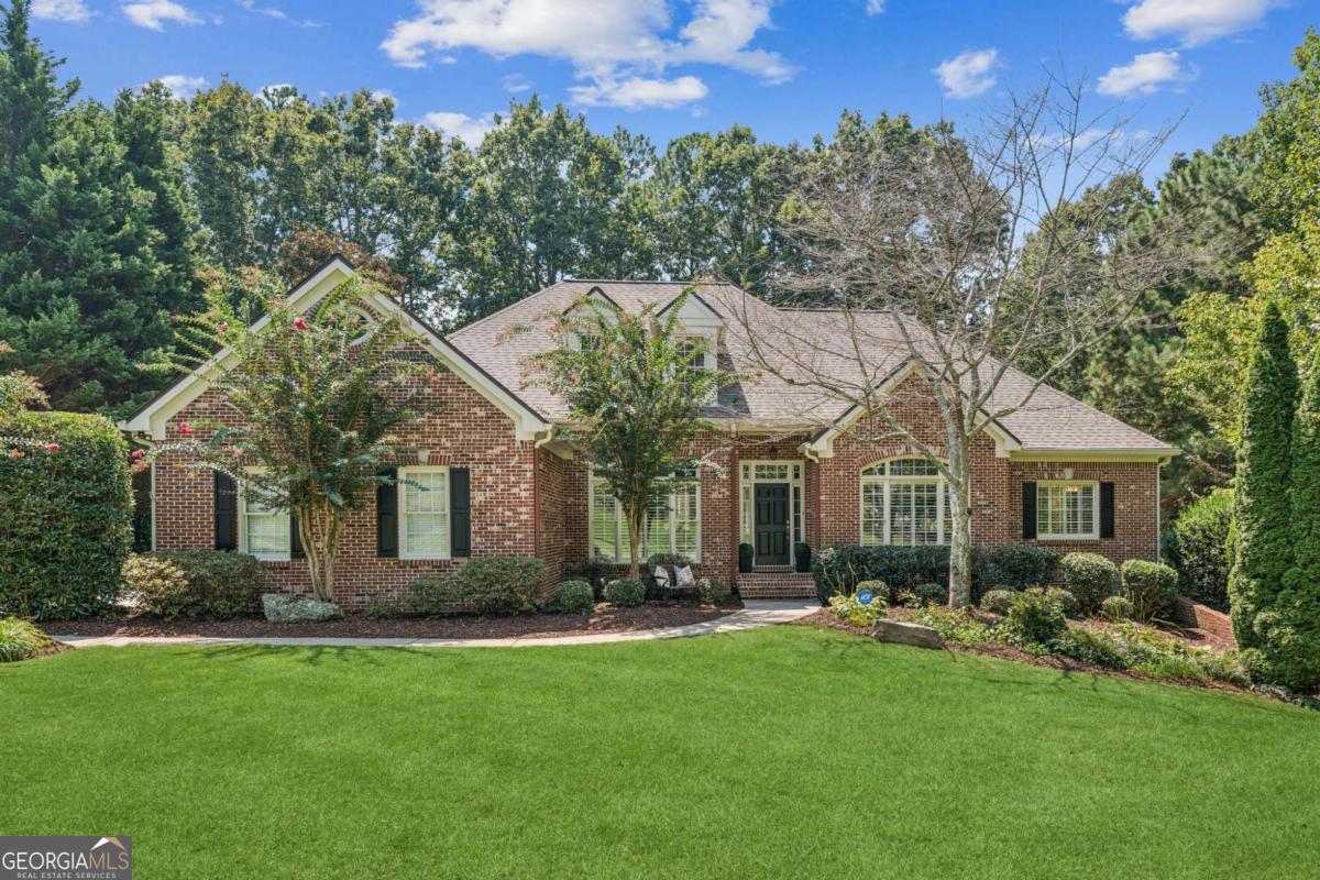 Discover this stunning lakefront ranch in the serene Birmingham Manor, a peaceful Alpharetta enclave with Cherokee County taxes. Meticulously maintained, this home offers tranquil lake views, ideal for kayaking, canoeing, or fishing. Highlights include a beautifully renovated kitchen featuring quartz countertops, Italian tile backsplash, new cabinetry, and stainless steel appliances. The home also boasts refinished hardwood floors, fresh interior and exterior paint, plantation shutters, a 2017 roof, and updated HVAC systems (2018), and newer water heater (2019 ). Primary bedroom with lake view on main level with 2 other generous sized bedrooms on the other side of the home. Upstairs is another spacious bedroom with an ensuite bathroom. Residence sits on over an acre lot. The professionally landscaped, fenced backyard includes a fire-pit, a concrete path, and a freshly painted deck with a retractable awning. A spacious unfinished basement awaits your personal touch. Located in the top-rated Creekview High School district, this home feels like a rural retreat yet is close to modern amenities. Enjoy low HOA fees and optional memberships for swim, tennis, or golf at the nearby Woodmont Country Club. Your dream lakeside escape awaits!