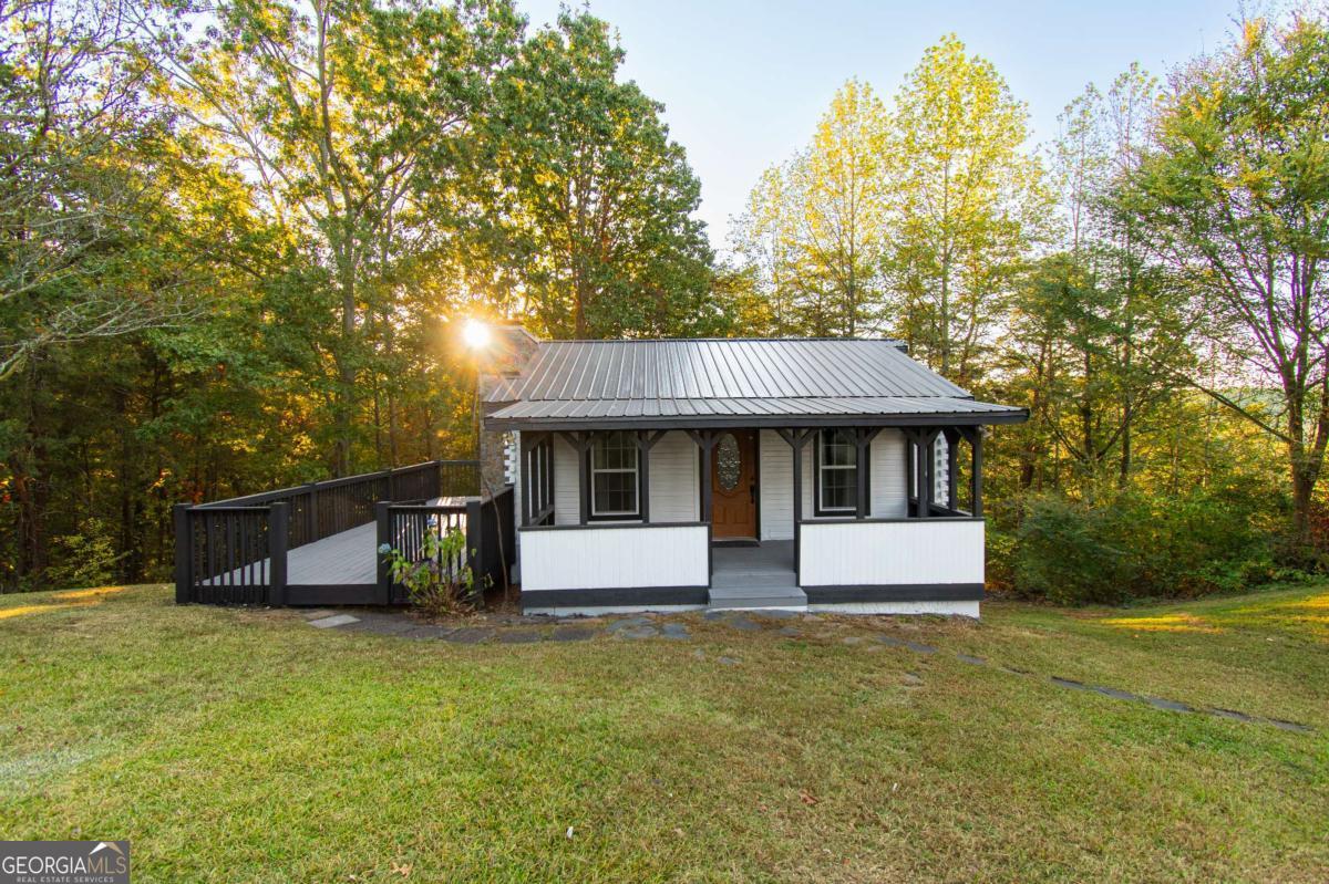 Charming Cabin in Beautiful North Georgia - Your Mountain Retreat Awaits! Welcome to your next home, second home, or vacation getaway! This delightful 2-bedroom, 2-bathroom cabin offers the perfect blend of comfort and rustic charm. Enjoy breathtaking views from the spacious sunroom, ideal for relaxing or entertaining year-round. The property also features a detached two-car garage, providing ample storage or workspace. Nestled in the serene North Georgia mountains, this peaceful retreat is the perfect escape from the everyday hustle. Don't miss this opportunity to own your slice of mountain paradise - schedule your showing today!