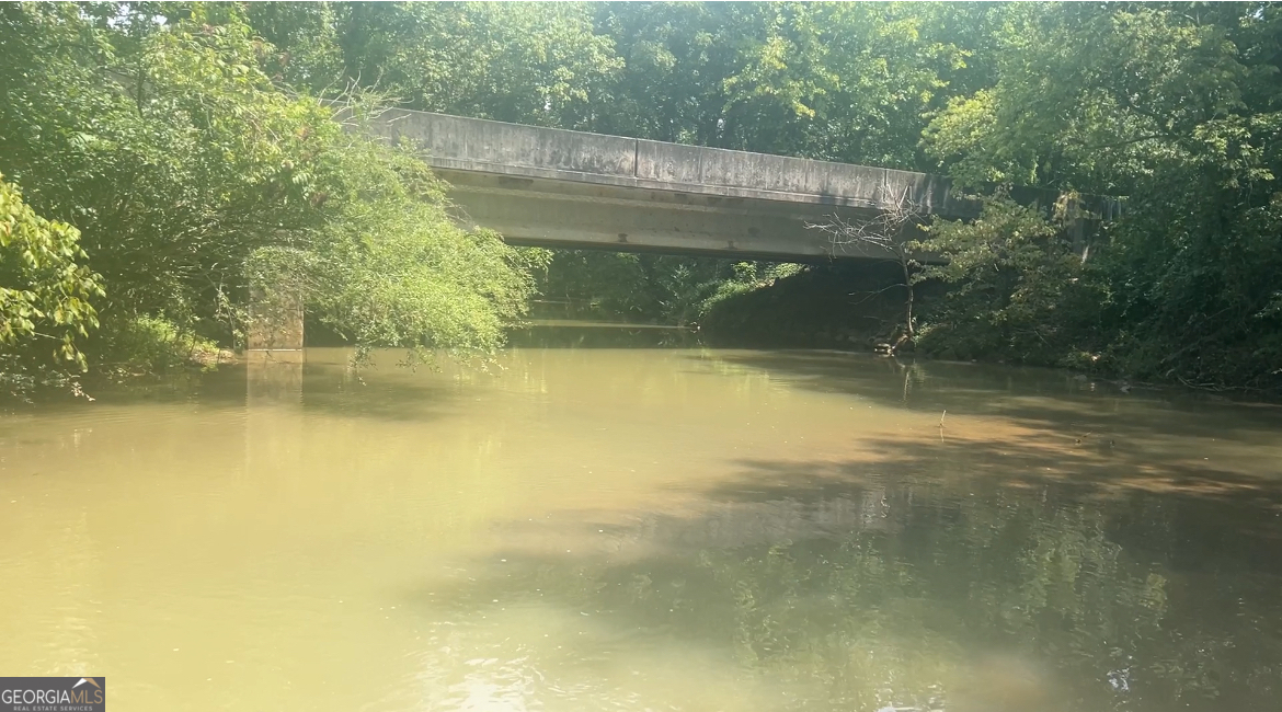 The memories that involve this land. Now it's time to pass it on the the new owner to make their own. Oothkalooga Creek flows through this beautiful property. Property features pasture, fence for the animals, city sewer with 2 taps, creek banks for fishing or relaxing listening to the sound of water rolling across the rocks. Bring your horses and build your dream home. A portion of the property is located in the flood zone. Buyer or buyers agent to verify property lines and all information regarding flood zone area. No septic, water or power on property. No sign on property. From Hwy 140 turn onto Shake Rag Rd. Right onto Woody Road. Property located on the right just before the bridge.