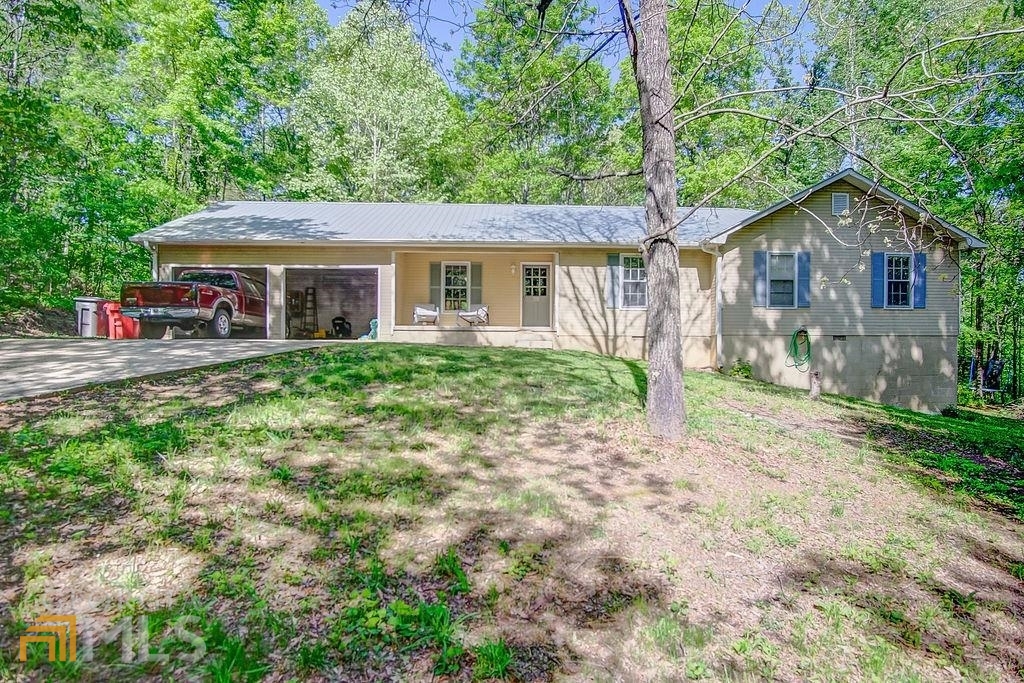Privacy in a neighborhood! This beautiful 3 bedroom 2 bathroom home has it all! Sits on over an acre of land! When you walk in you will be dazzled by the recently updated kitchen, off the carport you'll find a pantry and oversized laundry area! The living room with glass doors leading to the deck, that over looks a new firepit and swings! Down the hall 3 oversized bedrooms. The owners suite with a walk-in closet and new bathroom in the process of being renovated! From the new subfloor up. New flooring, new vanity, new toilet, new standup shower along with a new water heater! 2 lots at the end of a cul-de-sac! Call for your private showing today!