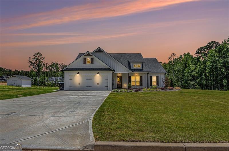 Set on a tranquil lot, this stunning 3 bed, 2 bath ranch home is less than a year old and loaded with upgrades! The open floor plan features a spacious kitchen with granite countertops, tile backsplash, under-cabinet lighting, walk-in pantry, and a large island overlooking the great room with 10' ceilings, custom built-ins, and a fireplace with shiplap accent. Enjoy luxury vinyl plank flooring in the main living areas, plush carpet in the bedrooms, and tile in the baths and laundry. The private primary suite boasts a double vanity, oversized walk-in tile shower, and granite counters.Outside, relax on the covered front or back porch, both with stained wood accents. The back porch includes a ceiling fan and cable outlet-perfect for entertaining! Beautiful Hardie Plank exterior with board-and-batten front and custom wood details. This home truly has it all-style, function, and comfort! Close to everything and in a quiet neighborhood. You wont want to miss this beauty.