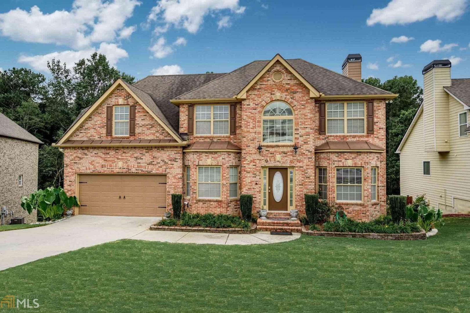 Don't miss out on this beautiful and well kept one owner home in Southfork swim/tennis community in Walton County and Loganville school district! This home has too many features to list- wifi thermostat, fenced backyard full of landscaping, sun room, covered deck, fireplace in master, and the list goes on. On the main floor the kitchen boasts granite counters, high-end SS appliances, and a large island. Every room is updated with modern paint, granite counters, and hardwood floors throughout. The master features a sitting area with fireplace and built-in bookshelves. The basement is fully finished with exterior entry, separate alarm and thermostat, stubbed-in kitchen, two rooms, game area, and full bath. This home will take your breath away!