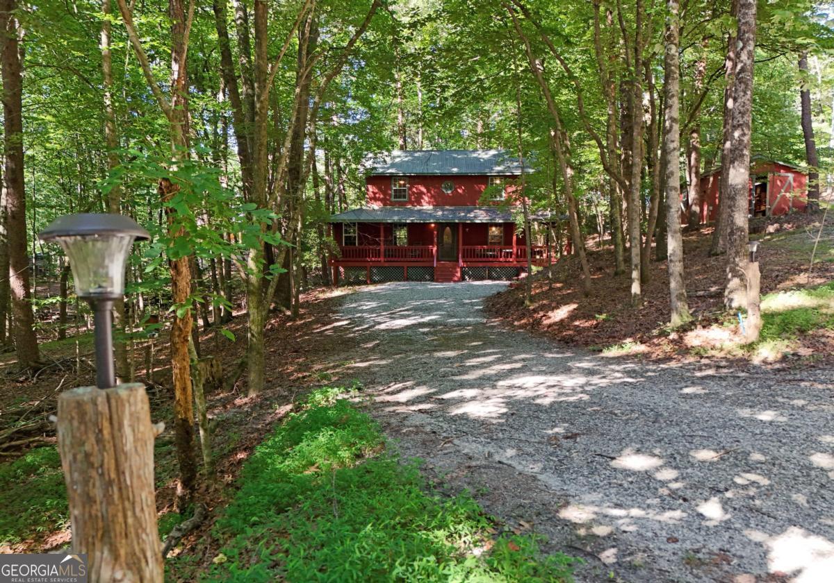 Wildwood on Pink Mountain . This Beautiful Mountain cabin sits on 1.5 gently rolling wooded acres. 2BR/1.5 BA , Wood T&G interior, wood floors. Central Heat Pump HVAC, Metal roof, wrap-around covered Porch leads to open rear deck shaded by beautiful trees. There is a detached Garage/workshop with a concrete floor, double swing doors, built in shelving for storage. Plenty of parking space. This community has a beautiful inground pool, private roads, and garbage pick up. Public water. Windstream kinetic internet. Under 5 miles to Downtown Cleveland. Excellent location to take in Helen and Sautee. Hiking, fishing, tubing, restaurants, and wineries just a short drive. The mountains are calling.