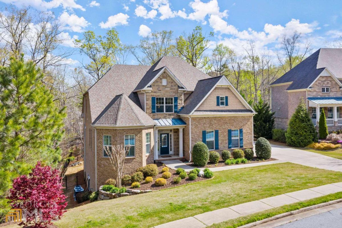 You will fall in love with this 3-sided brick, East Cobb stunner with the only primary bedroom on the main in the neighborhood. The expansive, private lot makes it an ideal location. You will immediately notice the flat front yard, driveway, outdoor lighting, 3-car side entry garage and professionally landscaped yard with irrigation system. Welcome home to the grand 2-story foyer with impressive modern chandelier lighting, oak tread stairs & hardwood flooring throughout the major living areas on the main. Host parties in the living room with 10CO coffered ceiling, & plantation shutters which transitions into the dining area. Delight serving guests in the well-lit dining space with traditional wainscoting, trey ceiling & beautifully lit designer chandelier. Enjoy cooking in the updated kitchen with white cabinetry, tile backsplash, granite countertops, stainless GE appliances, 5-burner gas cooktop, coffee bar & pantry. Gather in the heart of the home in the impressive 2-story family room with geometric chandelier lighting, picture windows, & stone gas fireplace flanked between built-ins with speaker system to enhance your music & TV experience. Unwind & relax fireside while watching your favorite show on the covered deck with panoramic views of nature in the private, wooded lot with fenced yard. Get away to your private retreat on the main in the oversized primary bedroom. Reset after a long day with a long soak in the bathroomCOs relaxing garden tub with separate frameless glass shower, double vanity with granite countertop & walk-in custom closet system. You will have plenty of space upstairs with 3 large secondary bedrooms with 9CO ceilings, one with an ensuite bath & the others share an adjoining bath with separate granite countertop vanities. Cheer on your sports team, watch a movie, work out,aor play your favorite game in the completely renovated terrace level with full bedroom & bathroom. You have plenty of storage and a workshop space to add the perfect touch for your lifestyle needs. Live in climate-controlled comfort at the touch of your fingertips with a phone app, remote controlled thermostat, & 3 HVAC units zoned for each level of the house, with the AC units on the main and upstairs being new. Award winning schools and option to join the Highland Pointe HOA offer events & amenities including an Olympic size swimming pool, 4 state-of-the-art tennis courts, clubhouse, playground, scenic lake, & hiking trails that make this your must-have home.