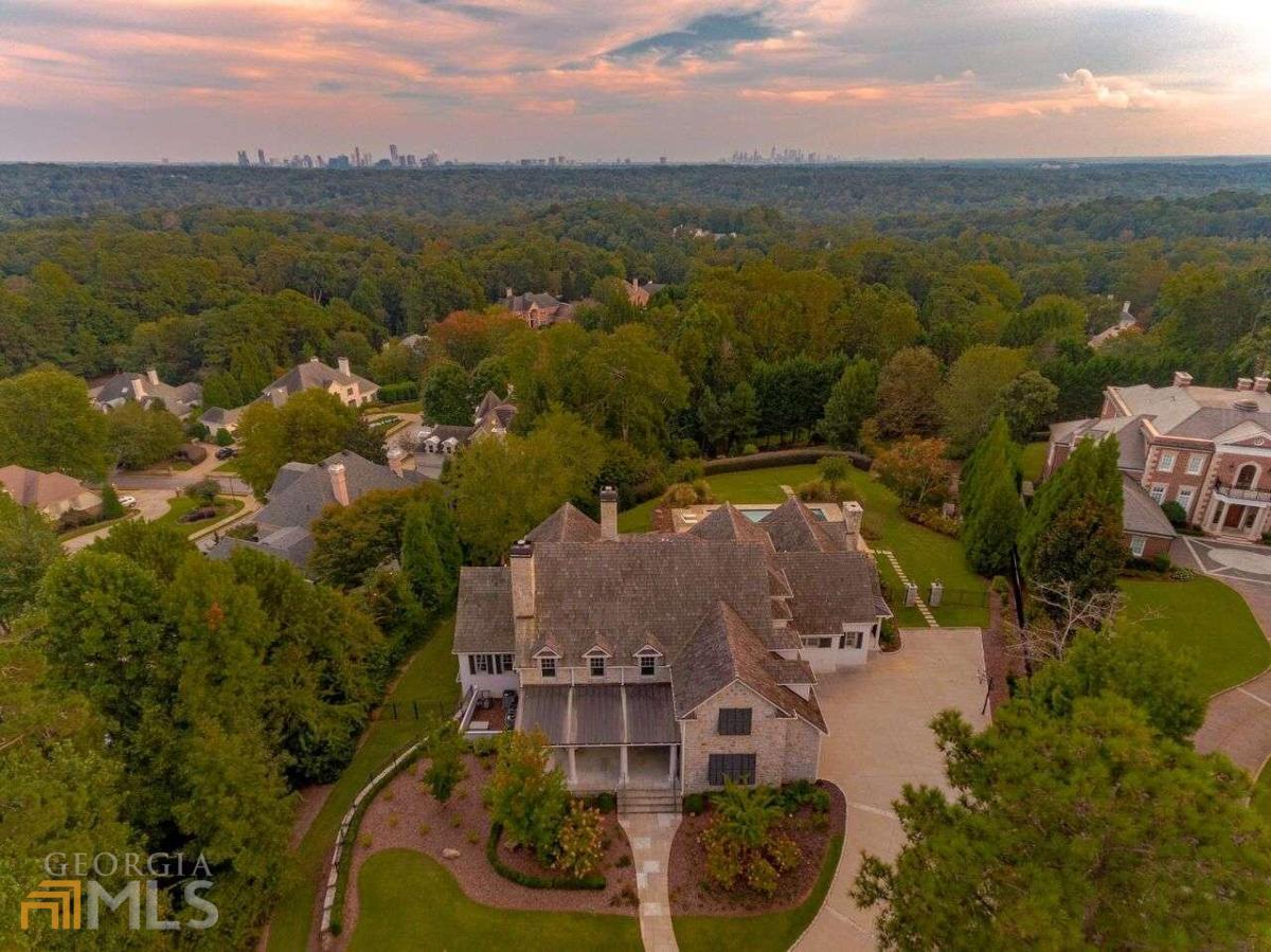 DO NOT DRIVE ONTO PROPERTY WITHOUT AN APPOINTMENT! Opportunities like this don't come along often....Perfectly positioned on one of the highest points in Atlanta, this meticulously designed custom creation on 1.7 acres provides skyline views that only a handful of other homes in the entire metro area possess! The home itself is equally as stunning as the view. From the gas lanterns adorning the front doors, to the pool and spa overlooking the city, and everything in between, it is perfection. Easily one-level living, the main floor consists of a fireside dining room and living room; gourmet kitchen; sunroom with air purification system; bar; built-in desk; laundry; 2 powder rooms. The exceptional main floor owner's retreat offers a luxurious bath and skyline views. Numerous doors open to a covered patio with fireplace and grilling station, as well as an uncovered patio area. The ideal flow for entertaining and viewing the skyline, both night and day. Upstairs houses 3 large guest rooms, each with a private en-suite bath. A recreation room, 2nd laundry and storage area (which could easily be converted to additional living space) complete the upper level. The basement awaits your customization. The views from this home are spectacular and best seen in person!